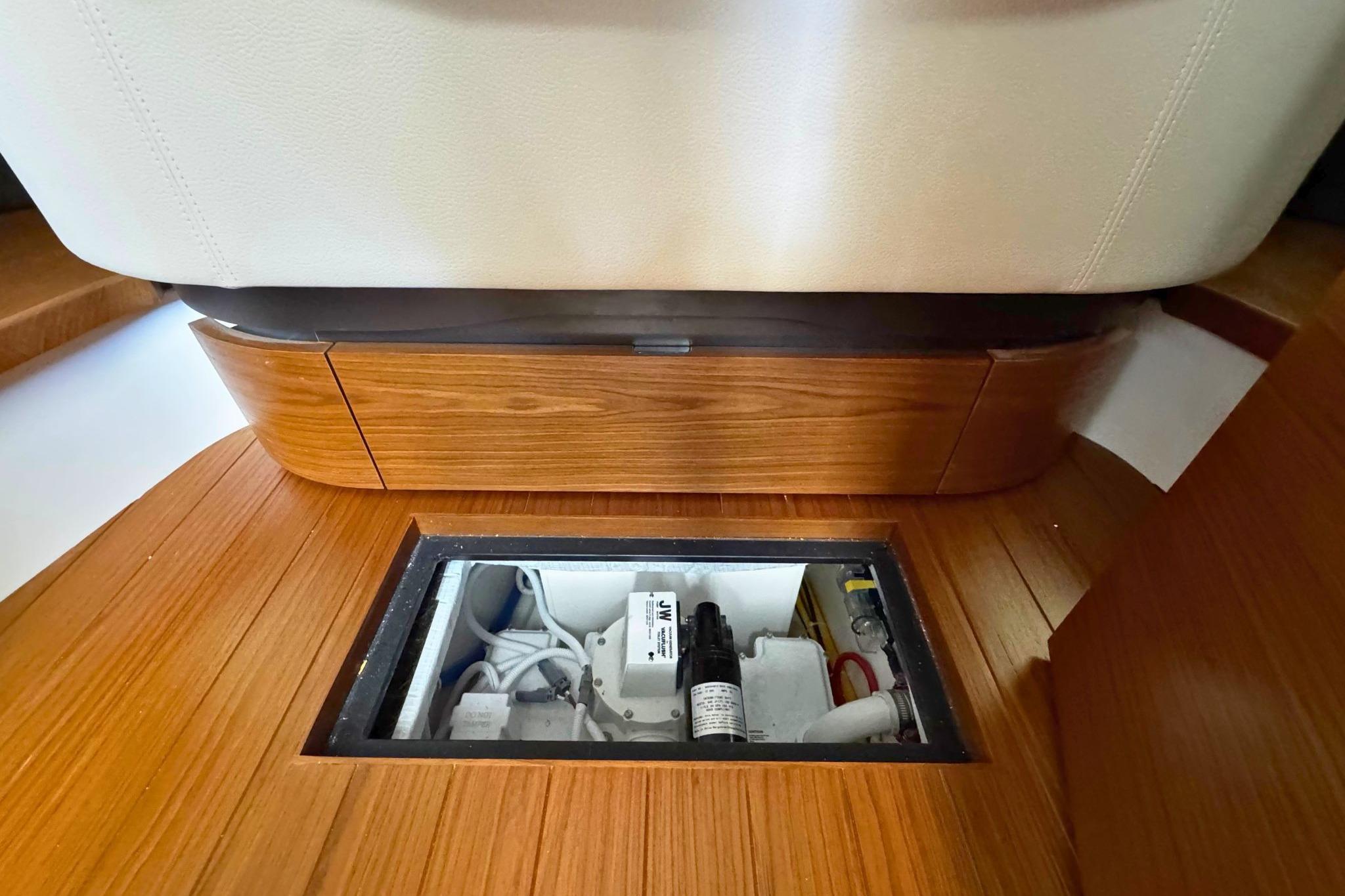 2027 Tiara Yachts 39 LE interior with open floor compartment, showcasing wiring and components.