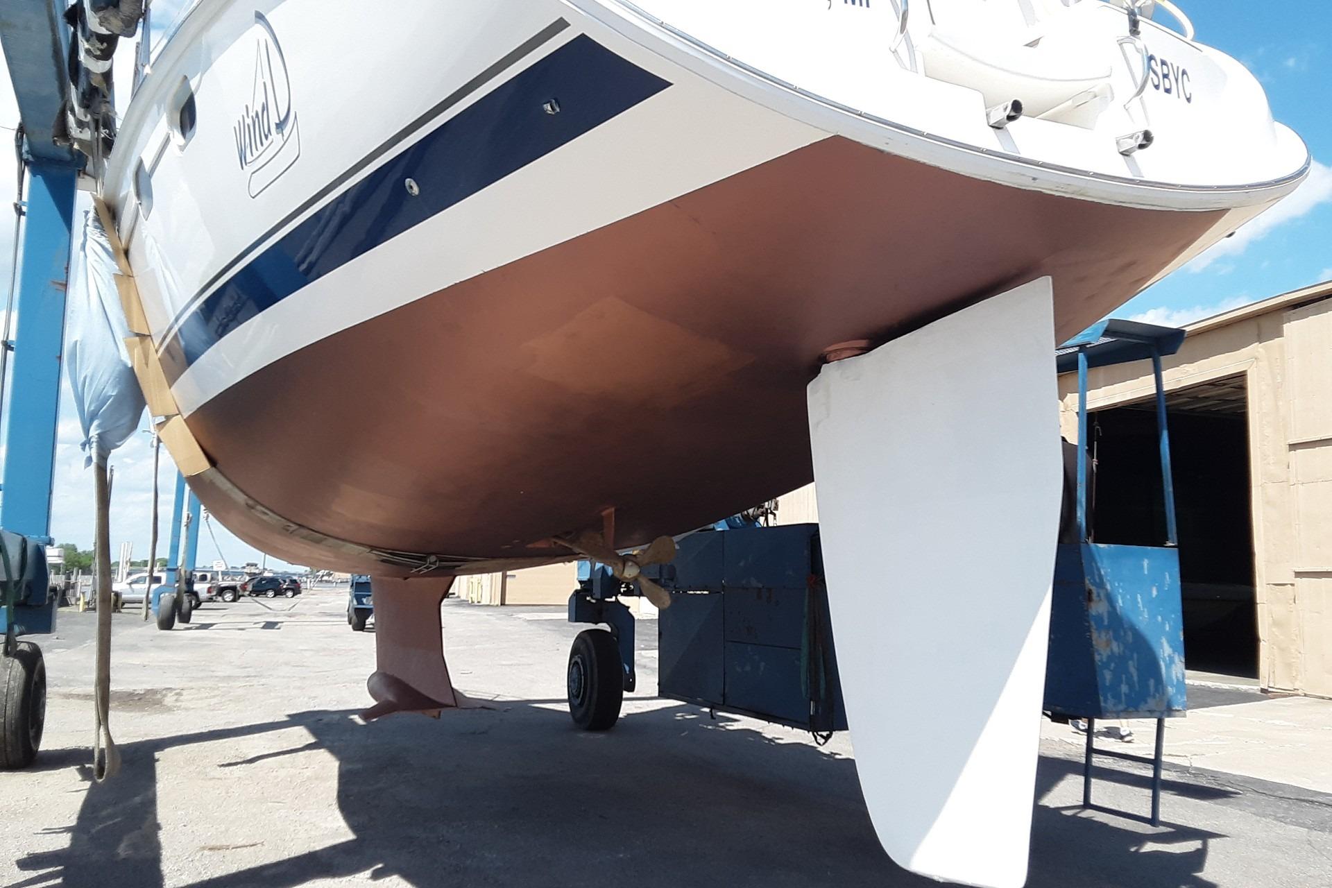 2005 Hunter 46LE sailboat on dry dock, showcasing hull and rudder.