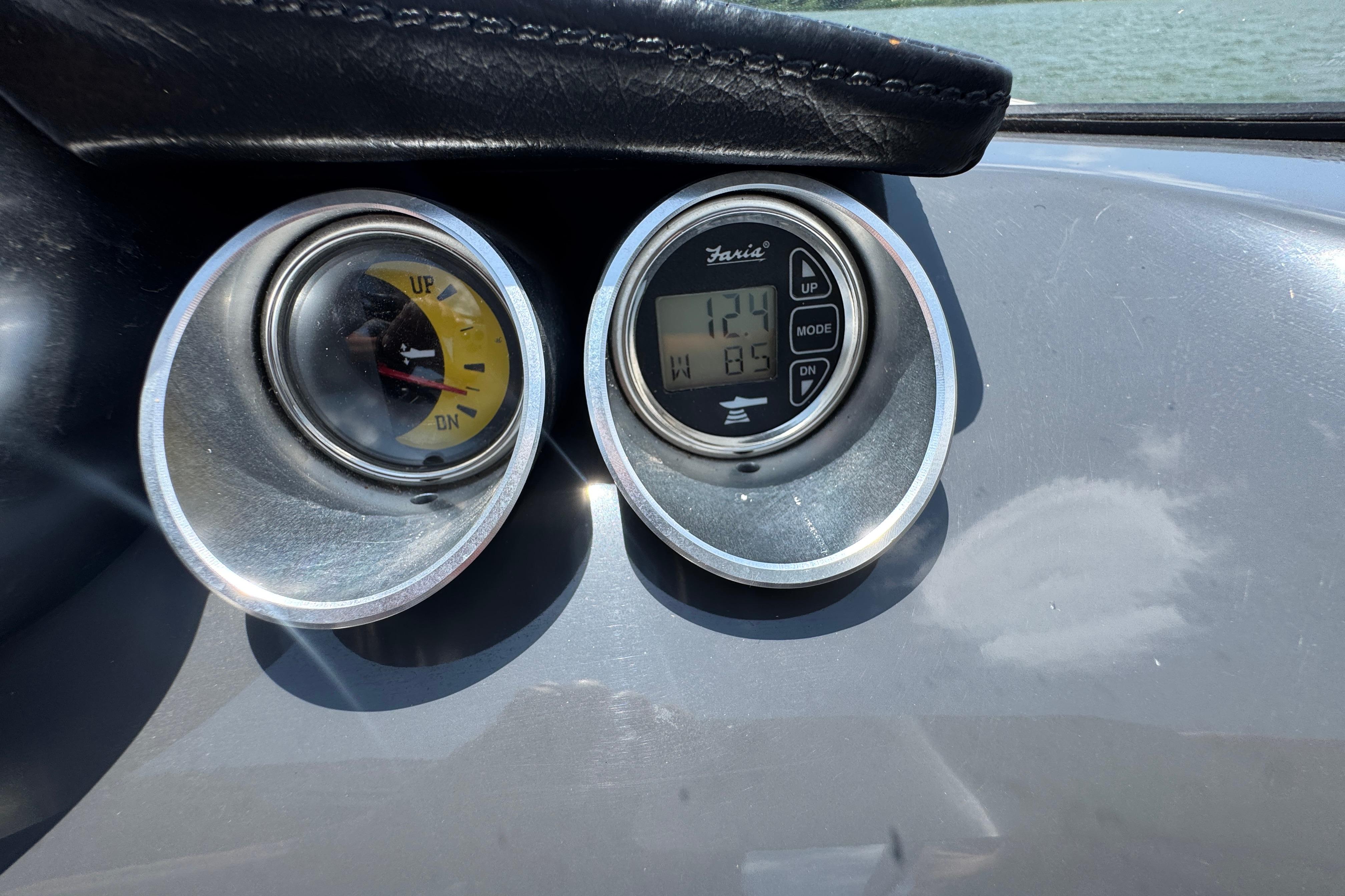 Dashboard gauges of a 2017 Glastron GT 225 boat, displaying trim and digital readings.