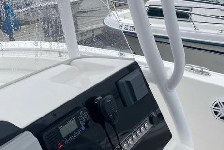 2020 Tidewater 220 CC boat console with navigation equipment and controls at a marina.