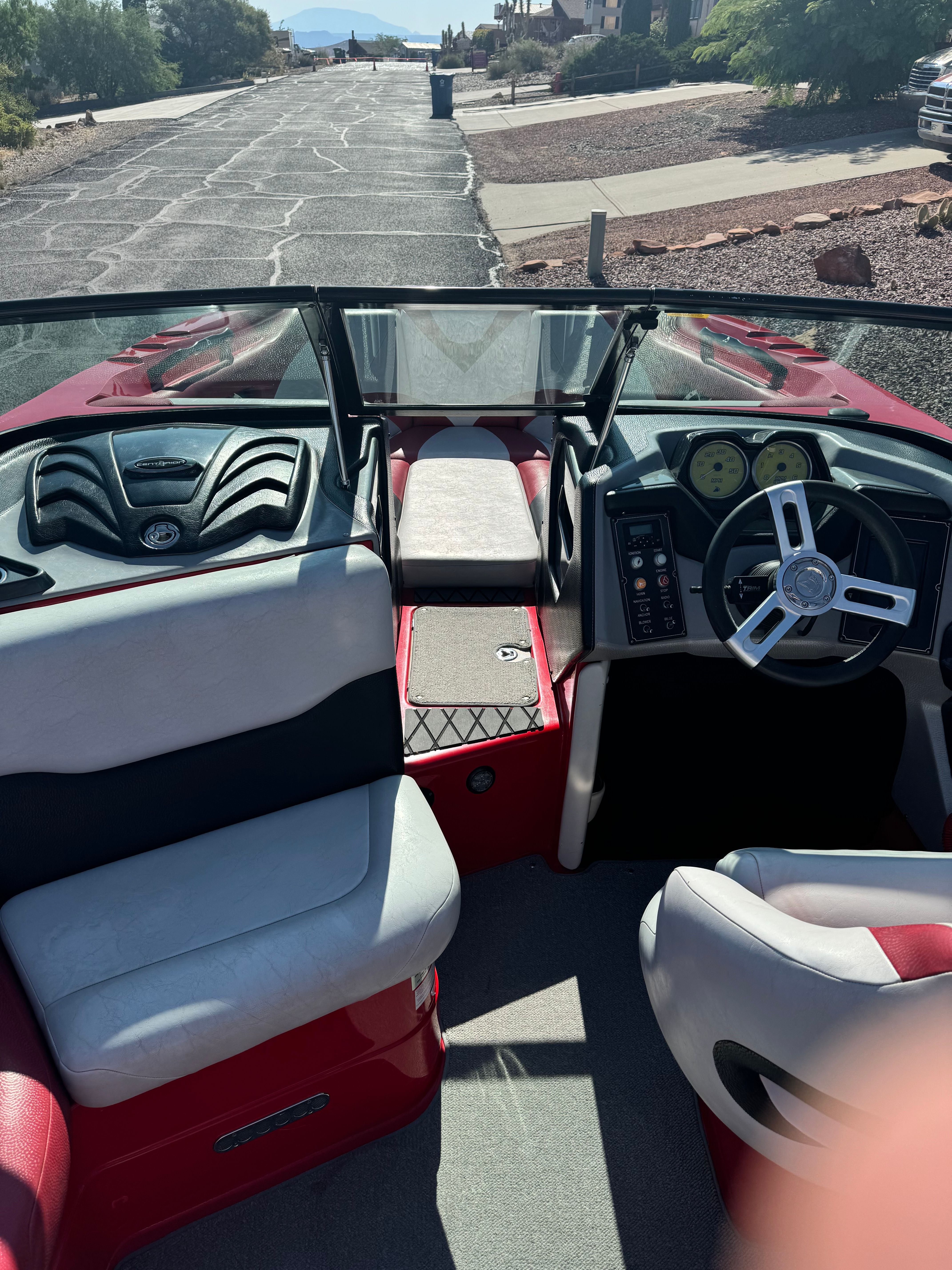 Interior of a 2014 Centurion Enzo FX44 boat with steering wheel and seats.