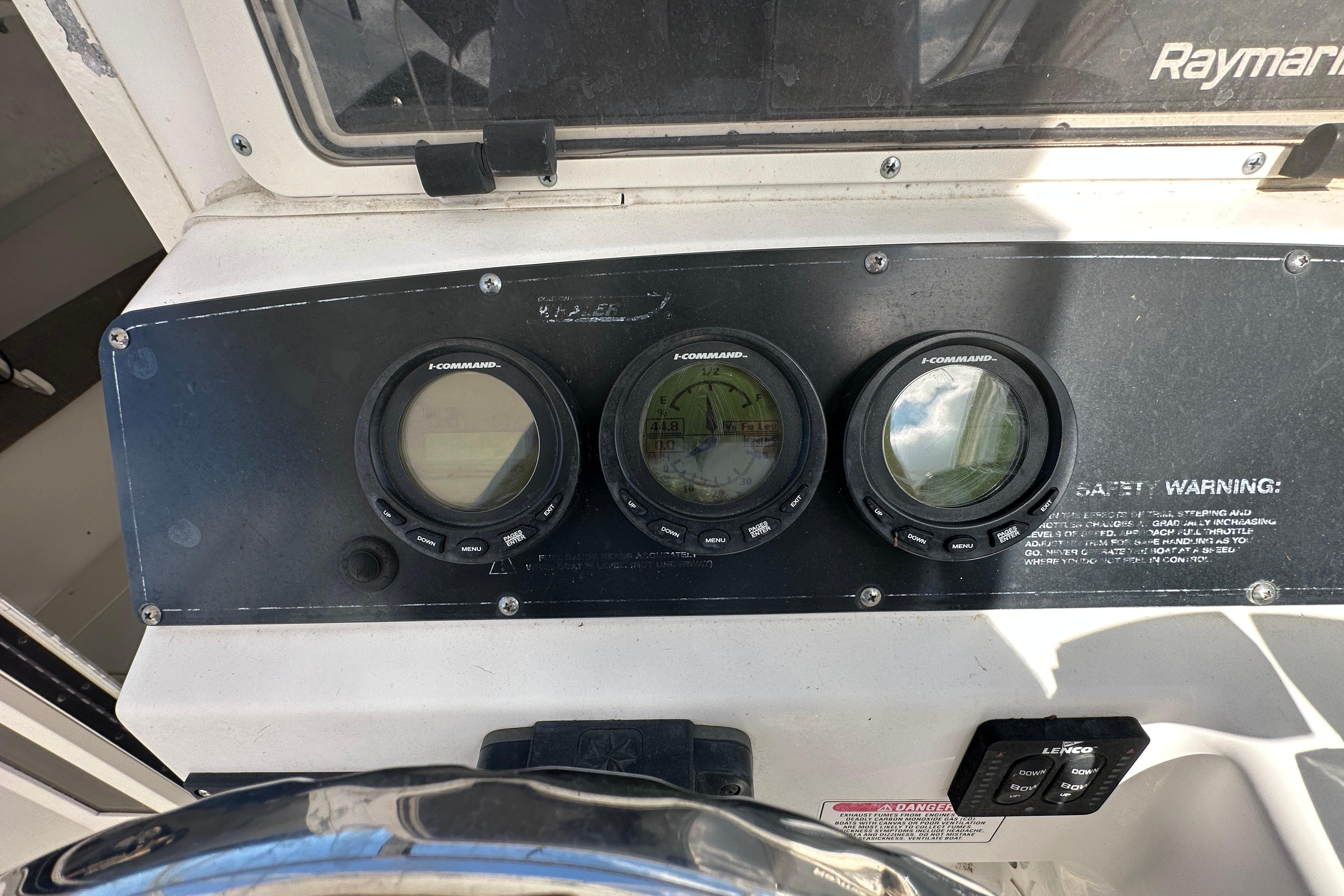 Dashboard of a 2001 Boston Whaler 23 Conquest boat with I-Command gauges.