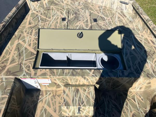 2025 Lowe Roughneck 2070 SC boat with camouflage design and storage compartments.