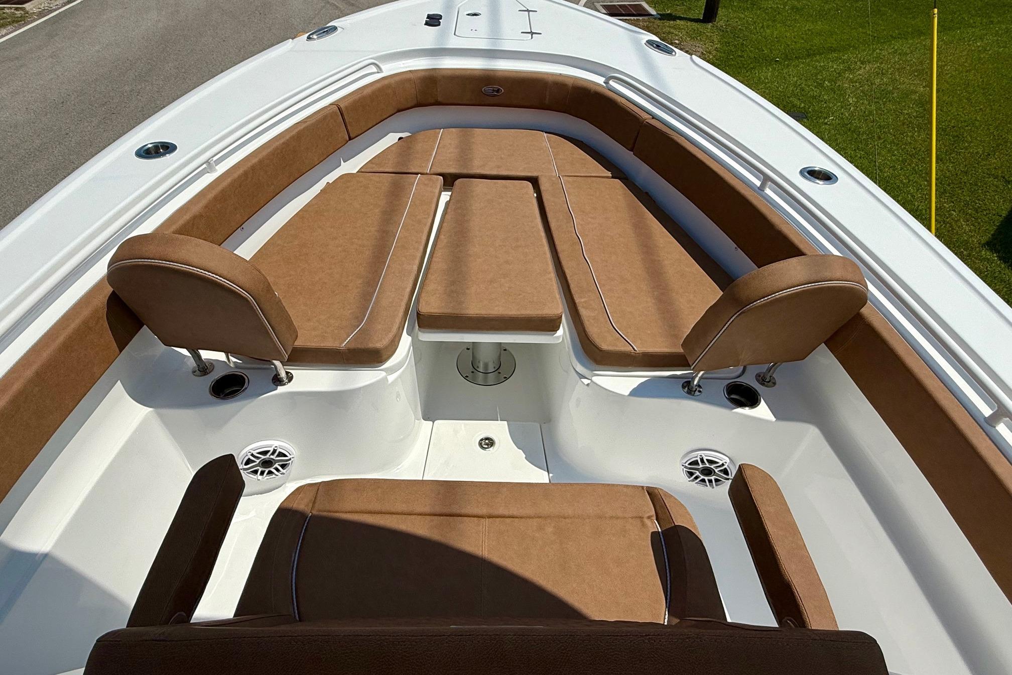 2026 Sea Hunt Ultra 305 SE boat interior with brown cushioned seating.