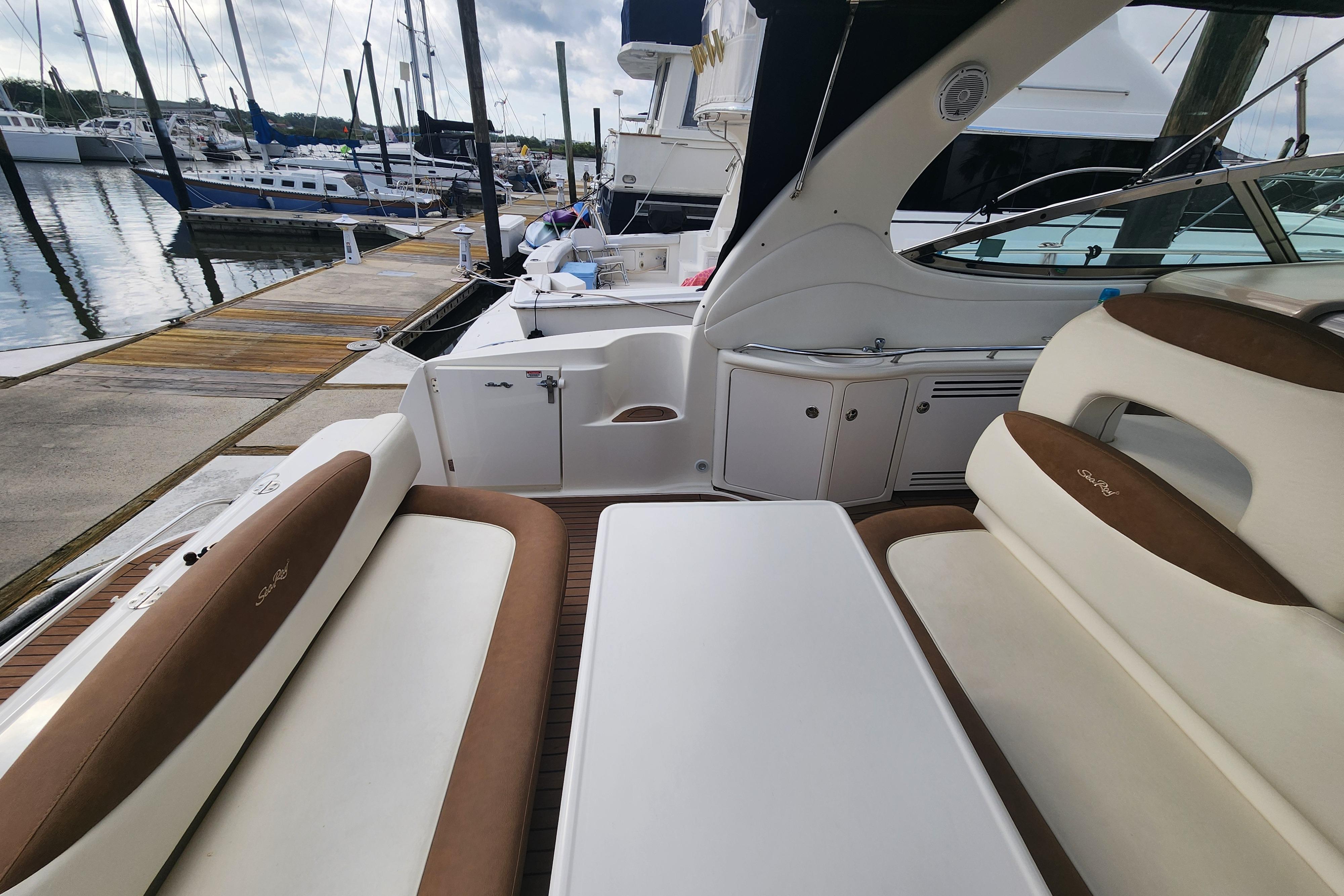 2003 Sea Ray 360 Sundancer yacht interior with seating, docked at marina.