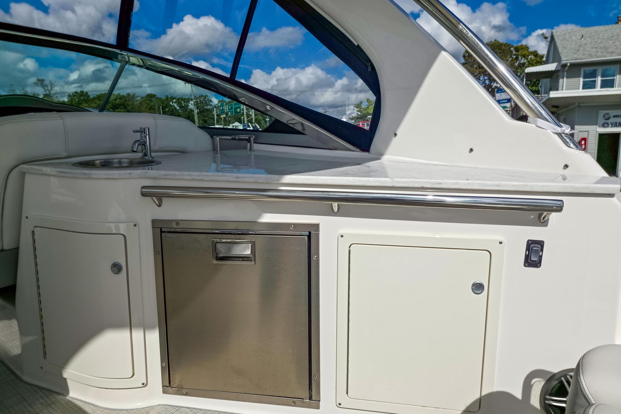 2026 Regal 33 XO yacht interior with kitchenette, sink, and storage cabinets.