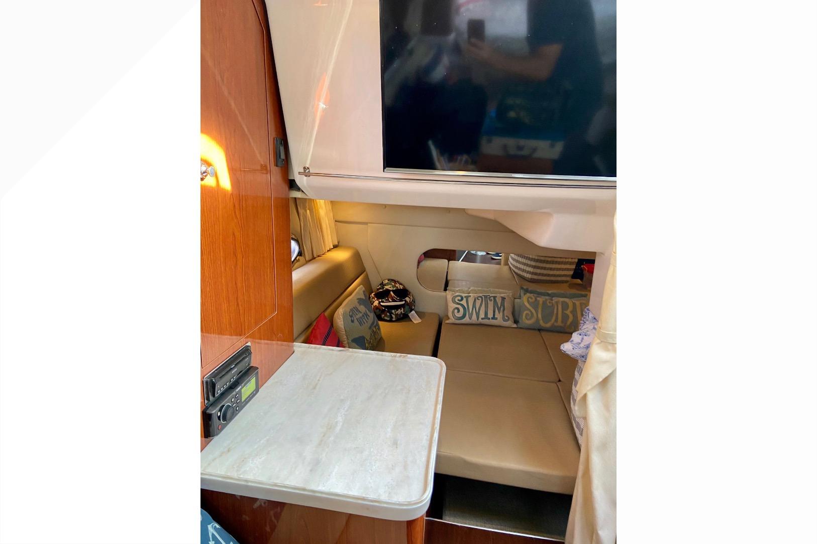 Interior of 2012 Regal 35 Express Cruiser with cozy seating and decor.