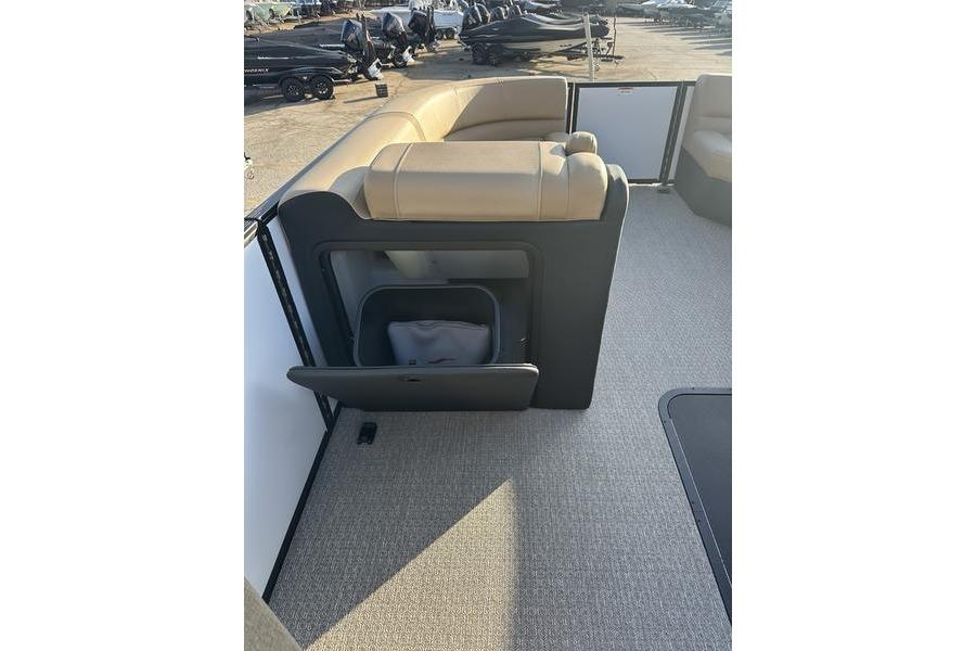Evotti 523CS 2026 boat interior with open storage compartment and beige seating.