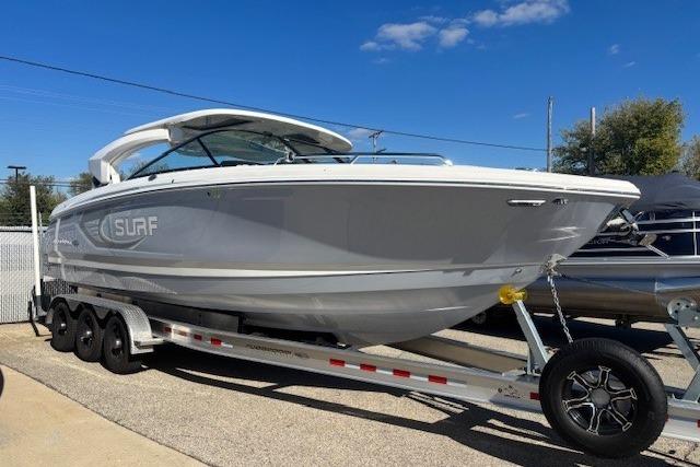 2024 Chaparral 30 Surf boat on trailer under clear blue sky.