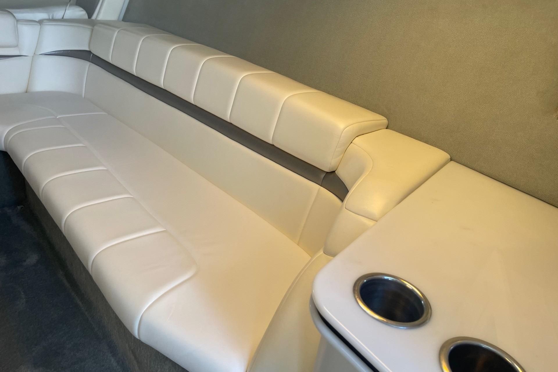 Interior of 2004 Formula 382 FASTech boat with beige seating and cup holders.