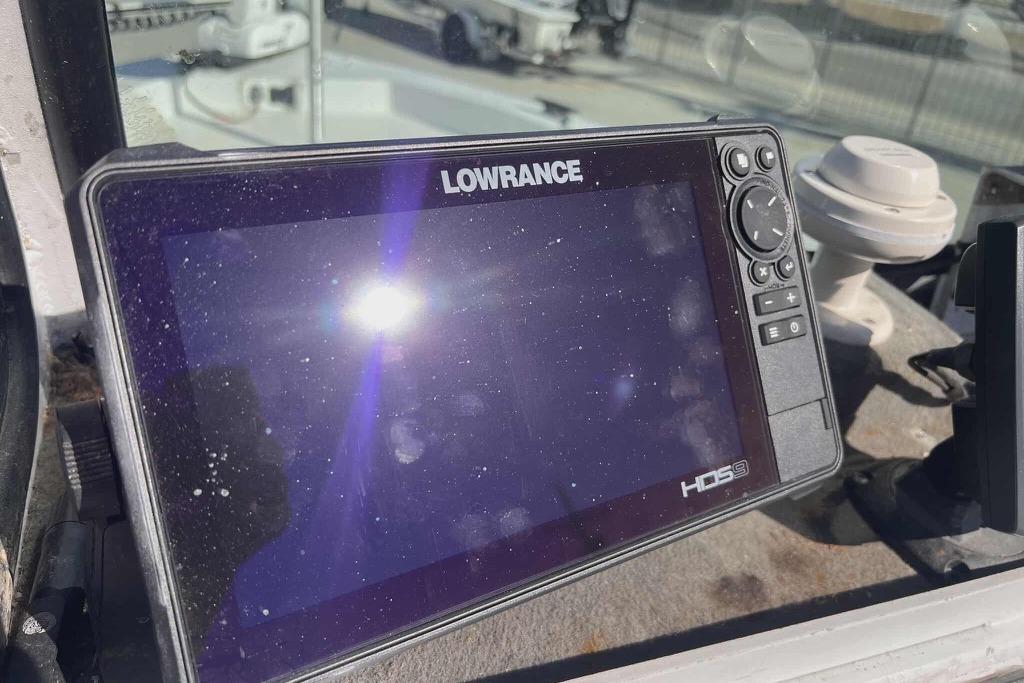 Lowrance HDS9 fishfinder on 1997 Gravois 20CC boat dashboard in sunlight.