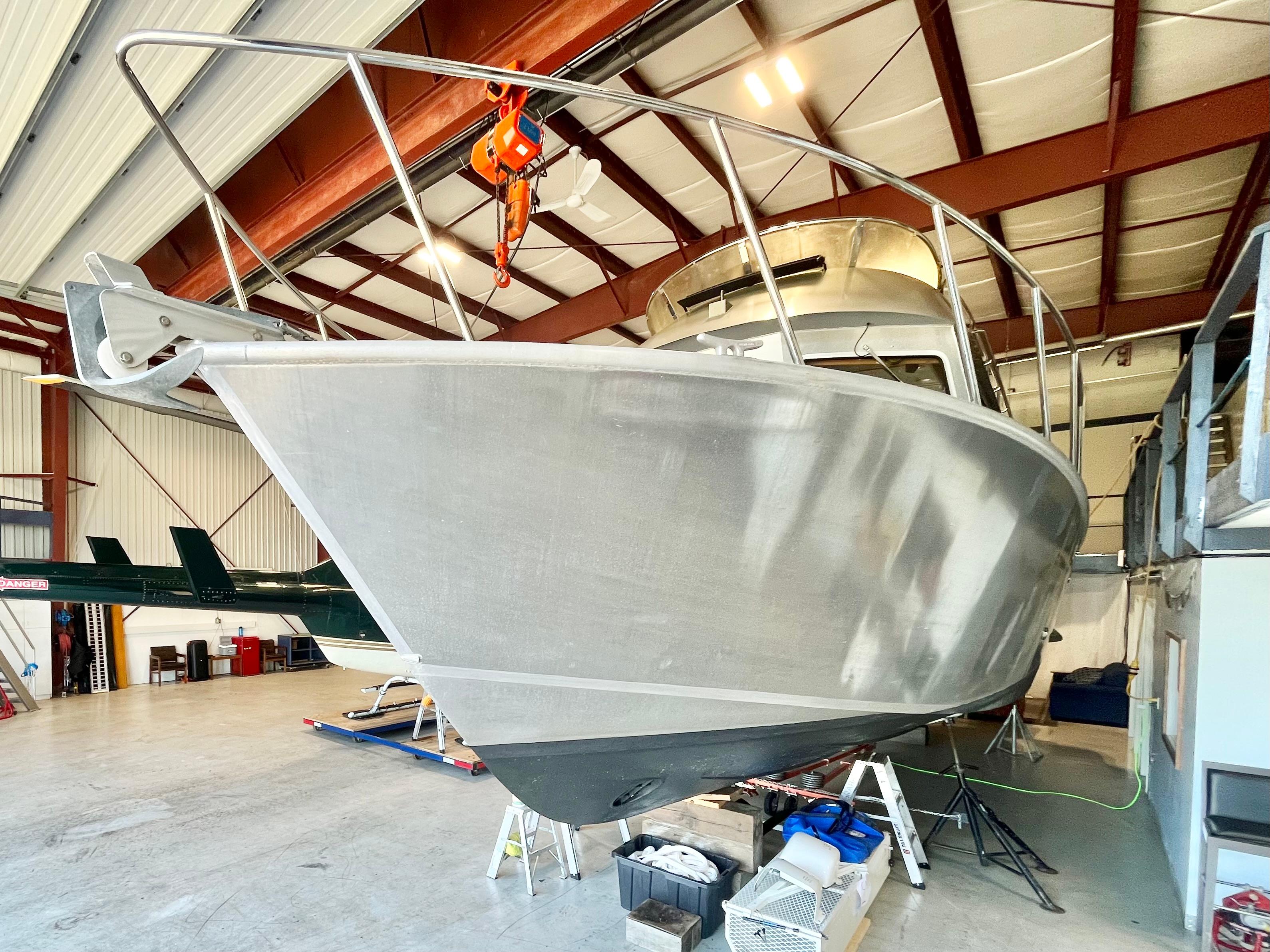 2007 Coastal Craft 36 Cruiser in a warehouse, showcasing its sleek aluminum hull.