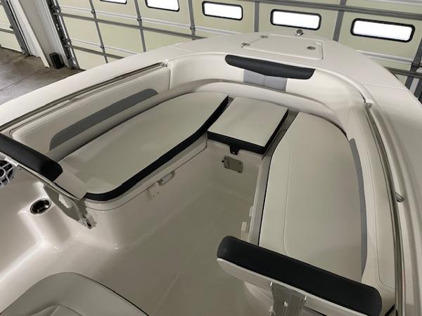 2025 Robalo R202 Explorer boat interior with cushioned seating and storage compartments.