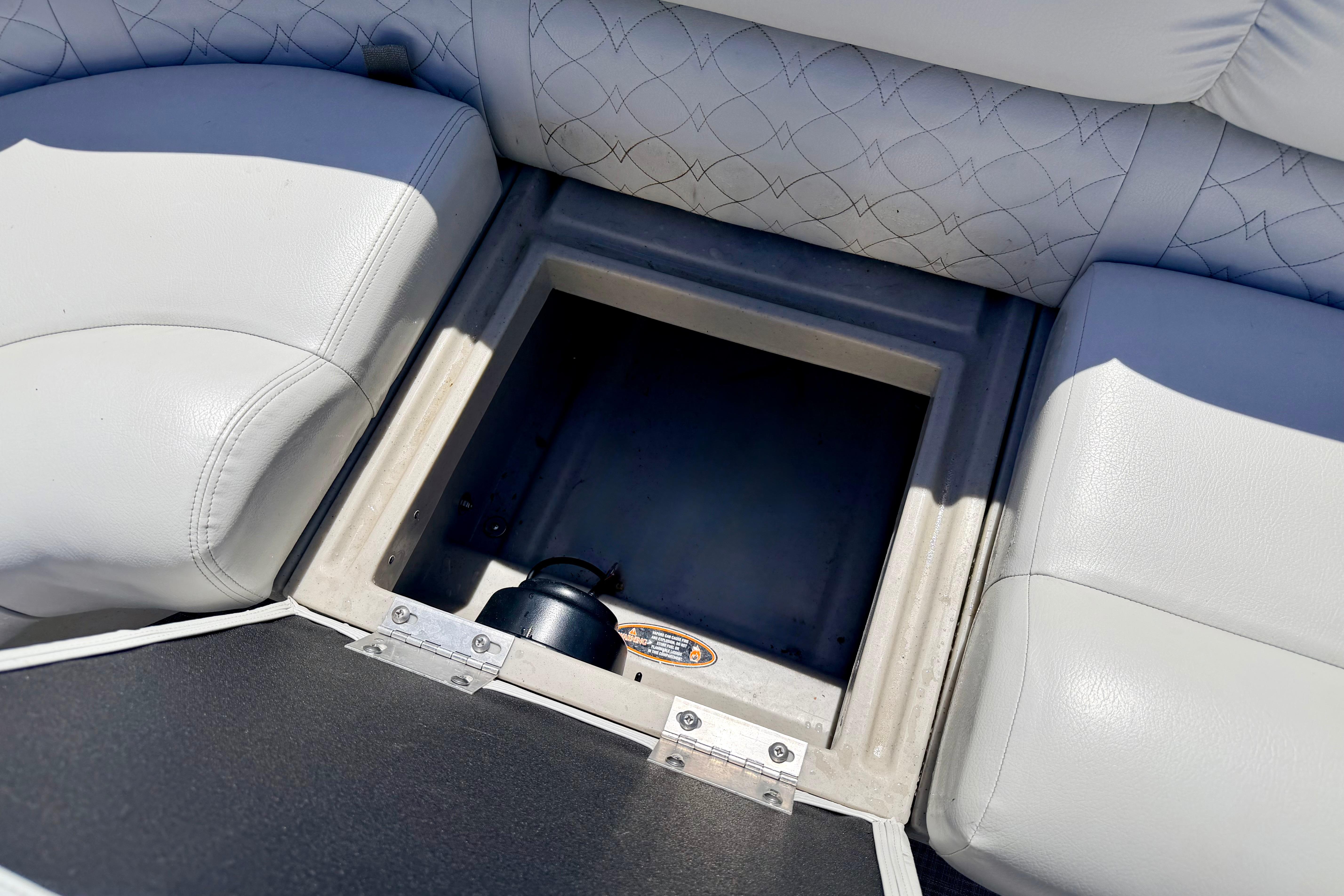 Storage compartment on 2019 Crestliner 240 Rally DX CW boat with cushioned seating.