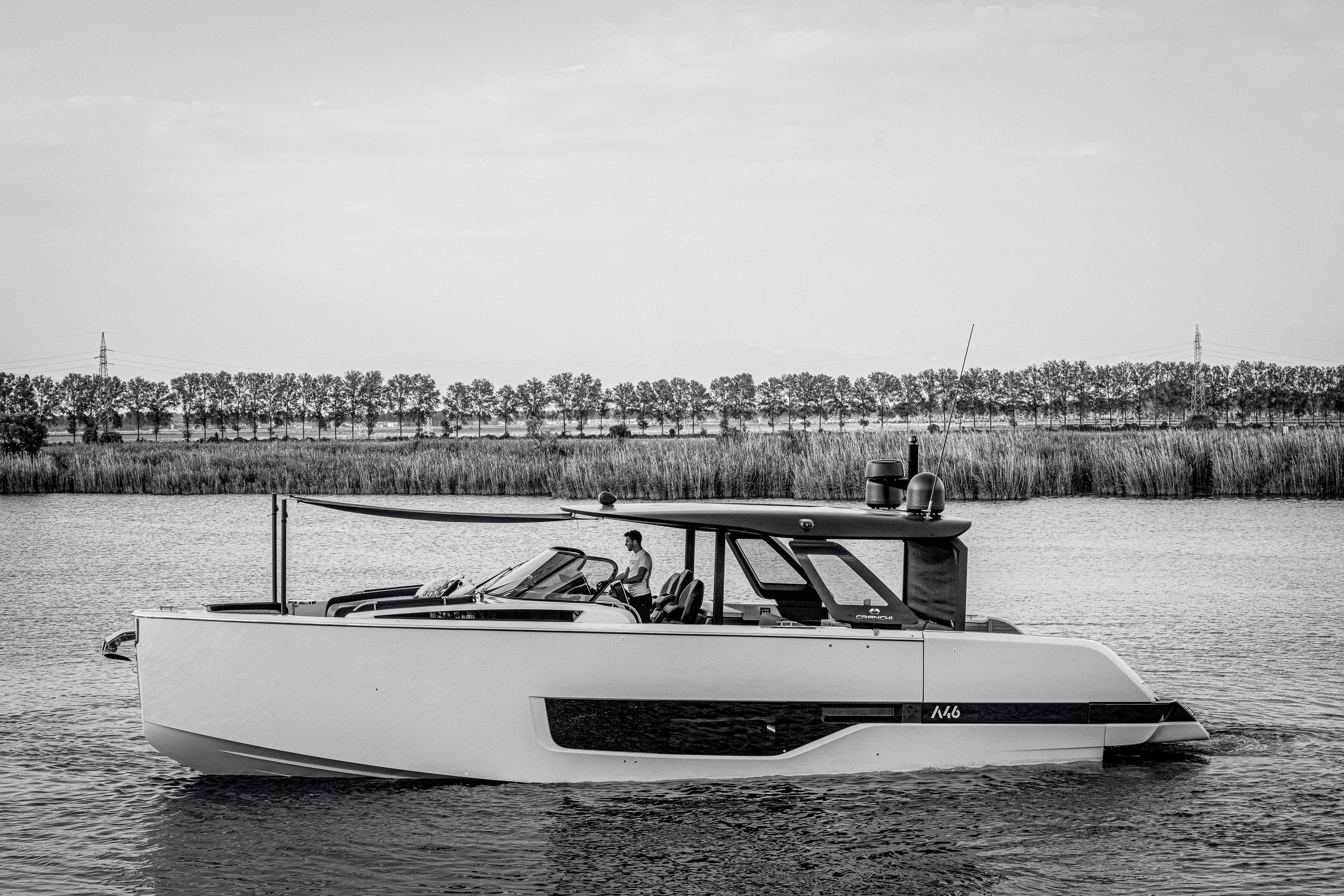 2026 Cranchi A46 Luxury Tender cruising on a serene river with a tree-lined background.