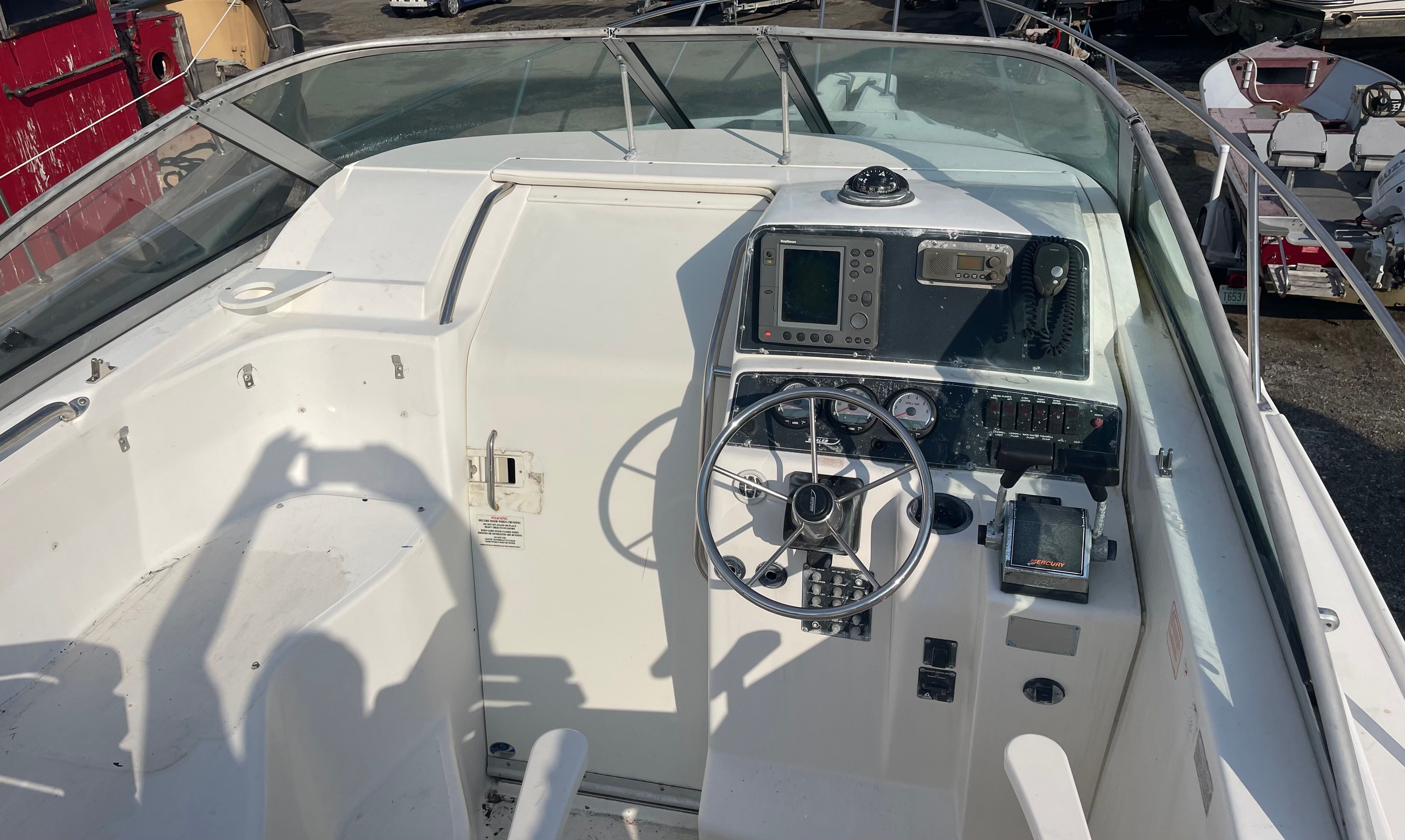 Cockpit of a 2001 Boston Whaler 26 Conquest with controls and instruments.