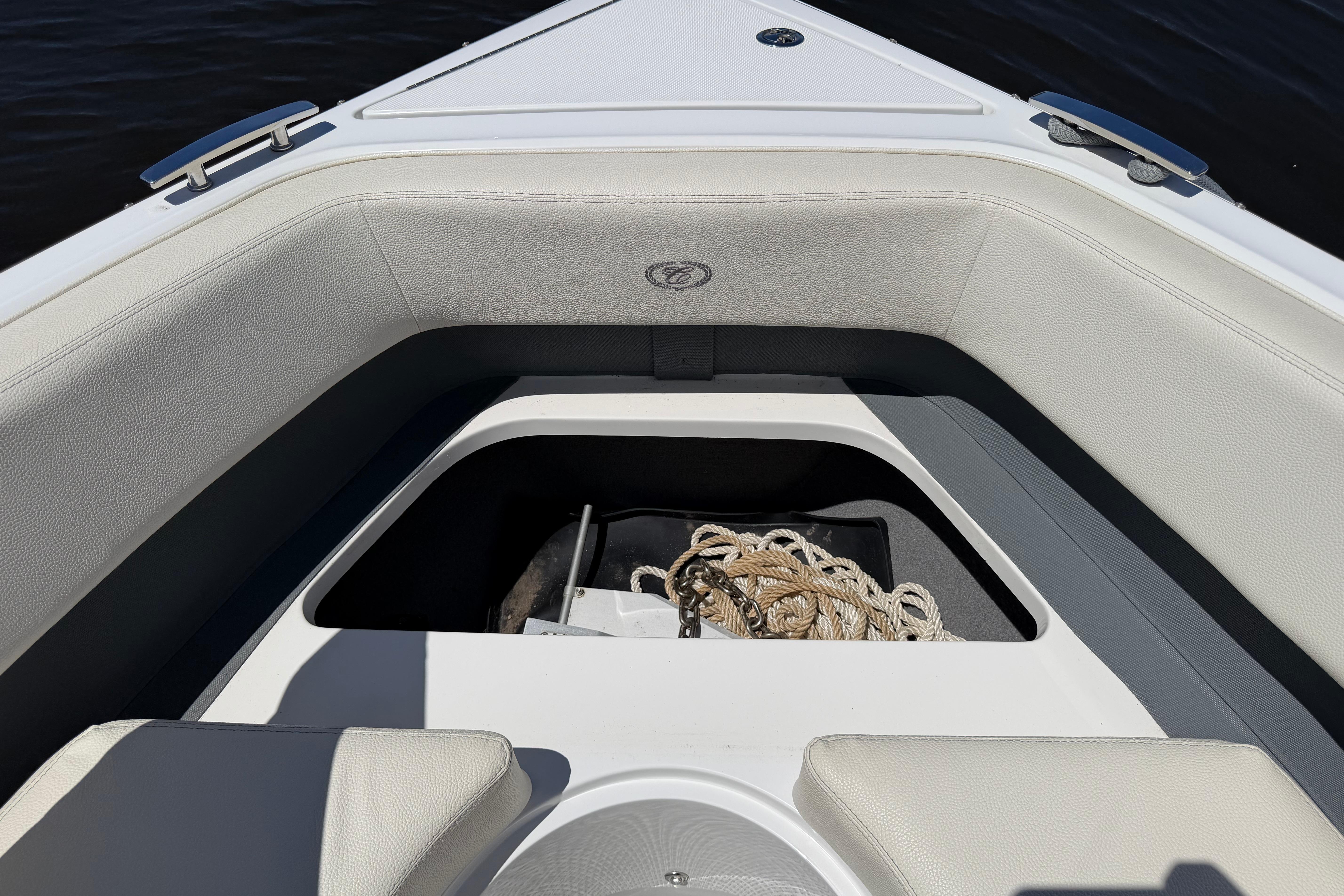 2020 Cobalt R3 boat interior with open storage compartment and coiled rope.