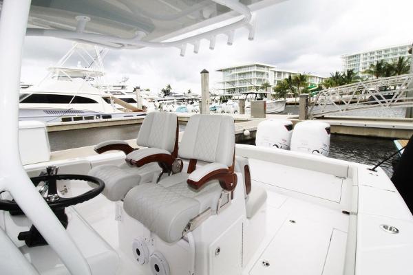 2024 Jupiter 34 HFS boat interior with dual seats and marina background.