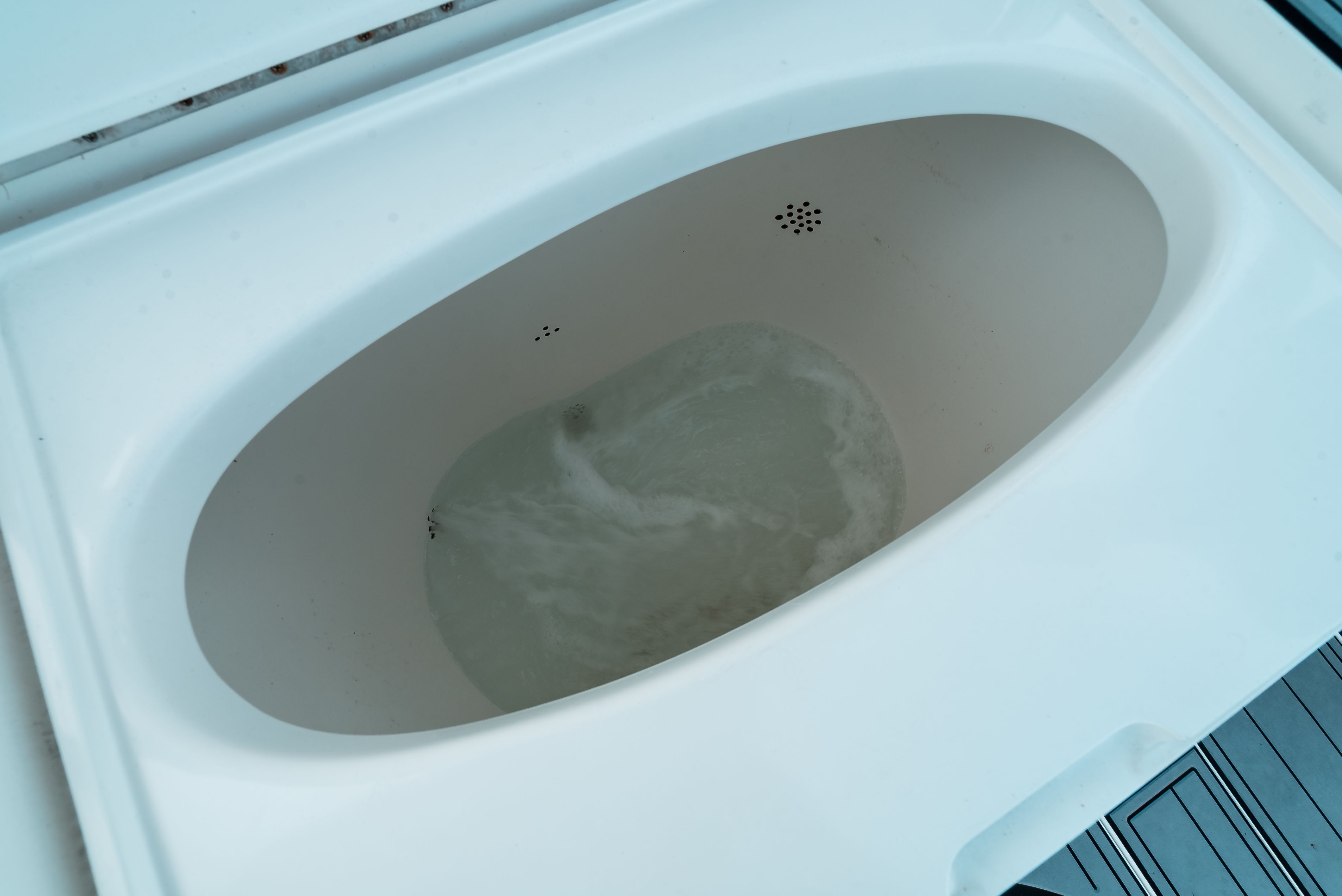 An oval basin with water, built into a boat, likely a fish tank.