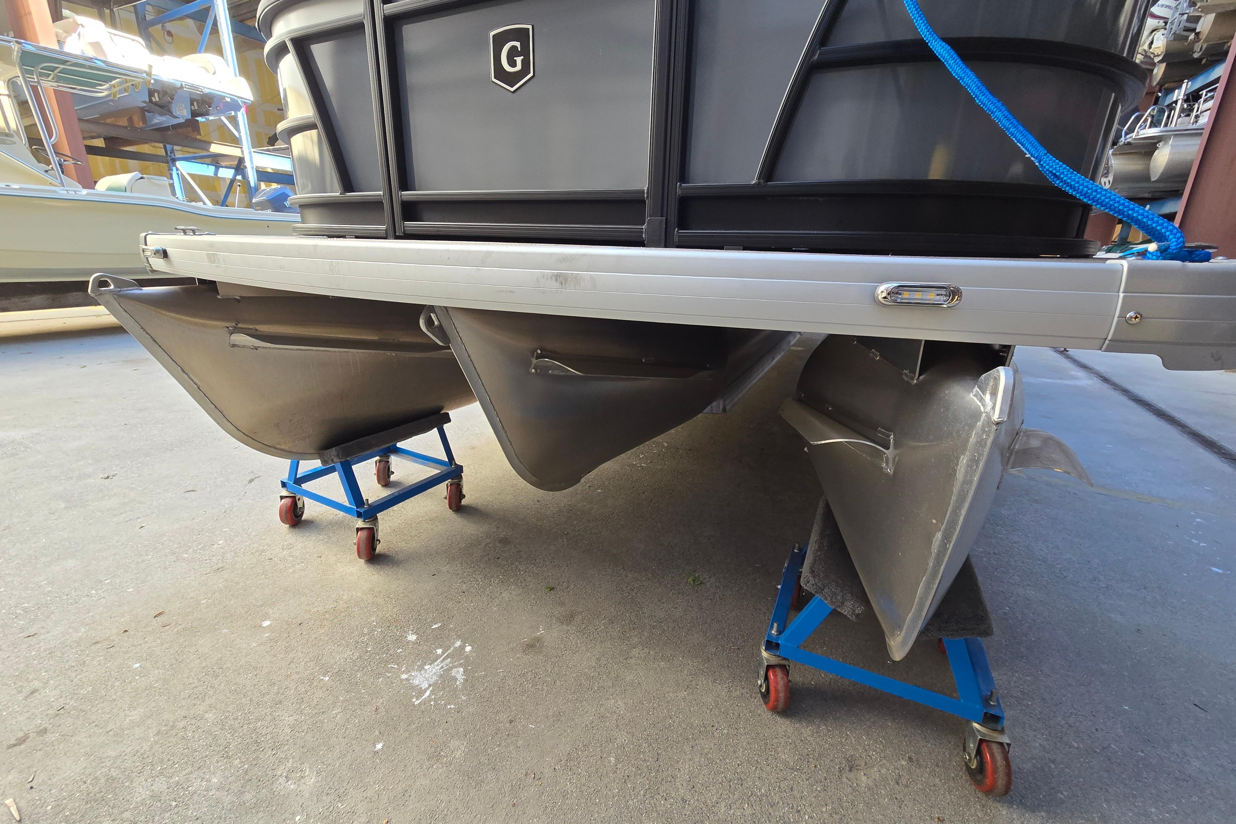 2024 Godfrey Sweetwater 2486 SB pontoon boat on stands in a storage area.
