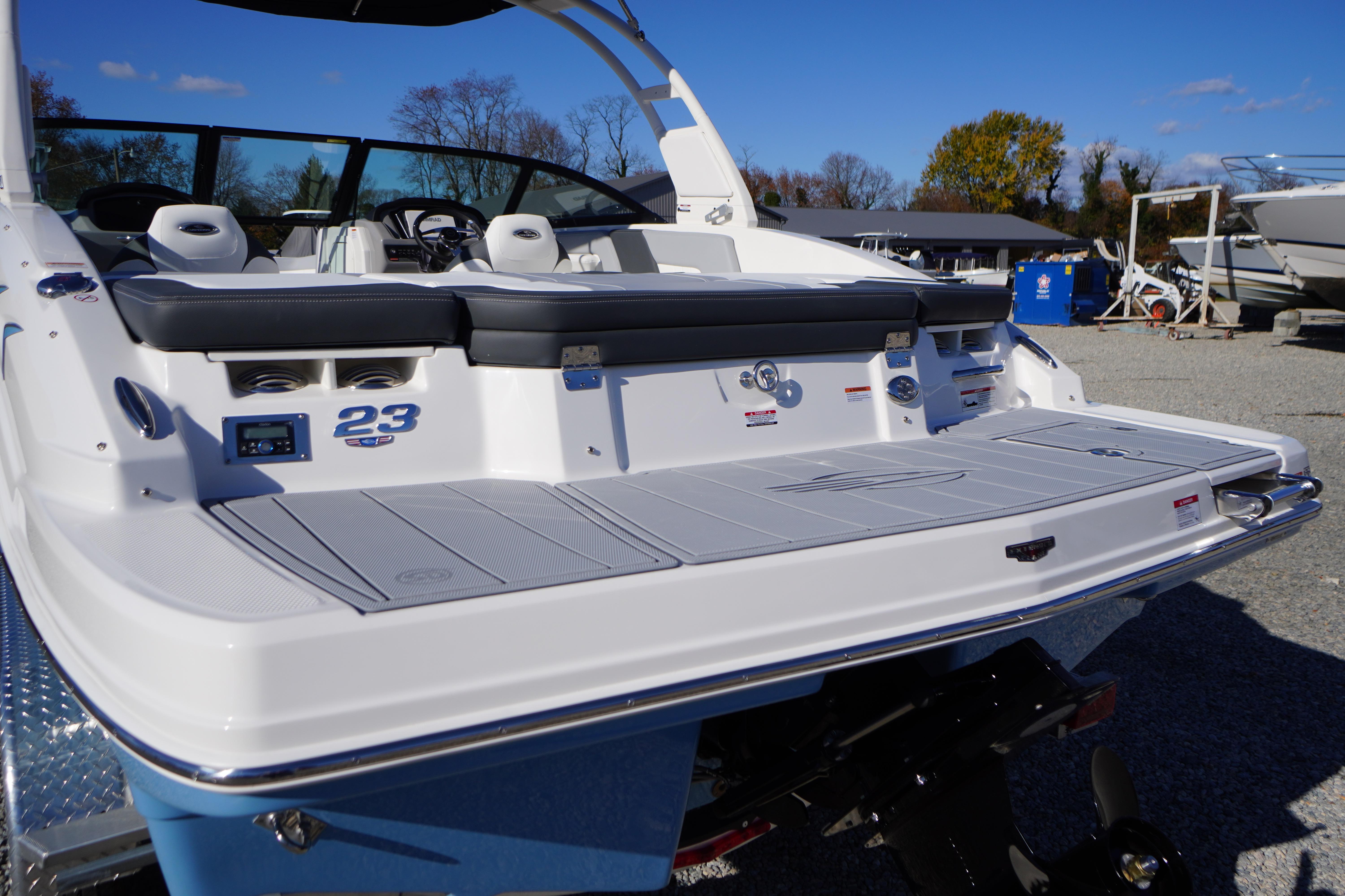 2026 Chaparral 23 SSi boat with sleek design and spacious seating, displayed outdoors.