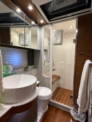 Luxurious bathroom in a 2019 Tiara Yachts C53 with modern fixtures and wooden accents.