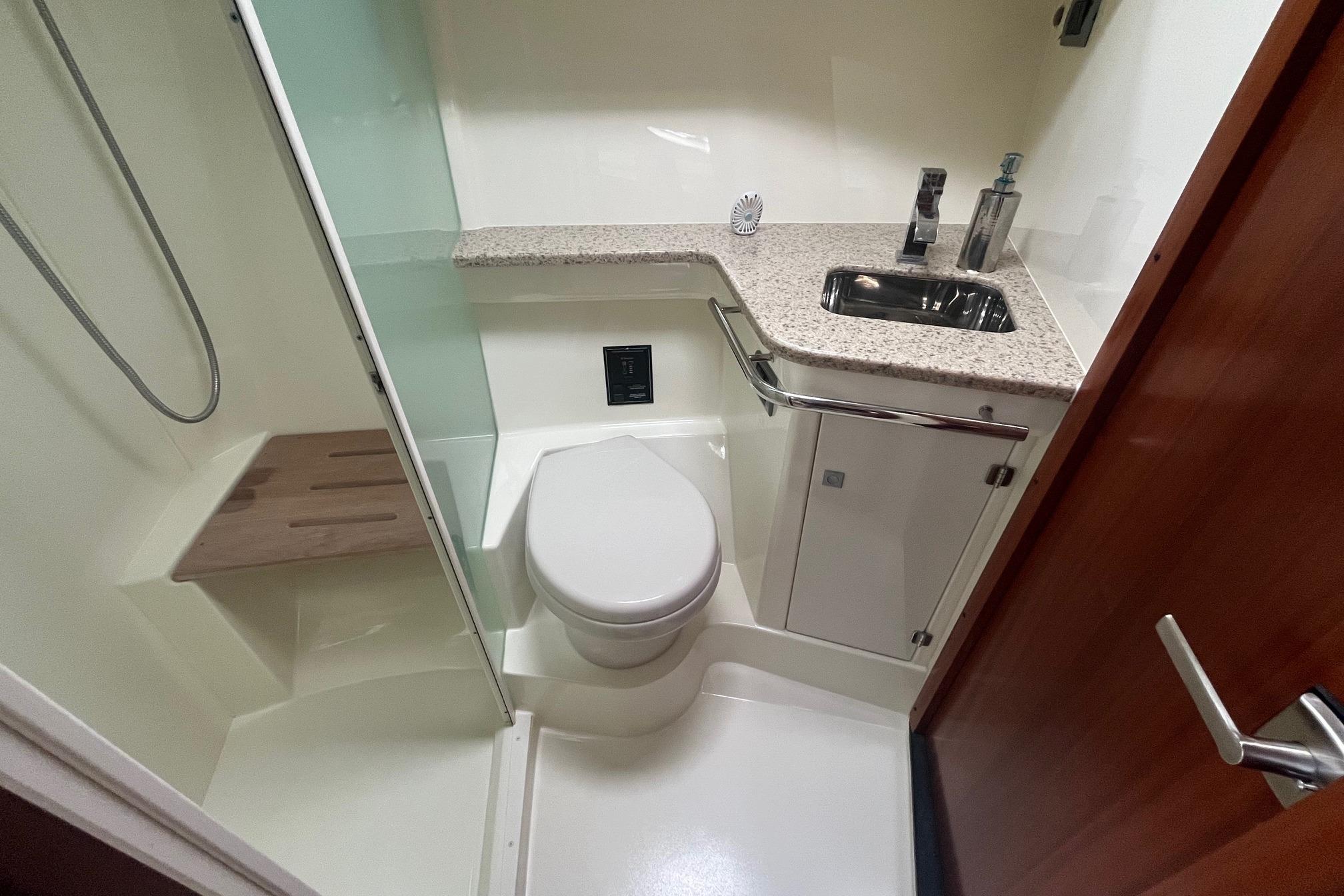 Bathroom interior of 2010 Monterey 400 Sport Yacht with shower, toilet, and sink.