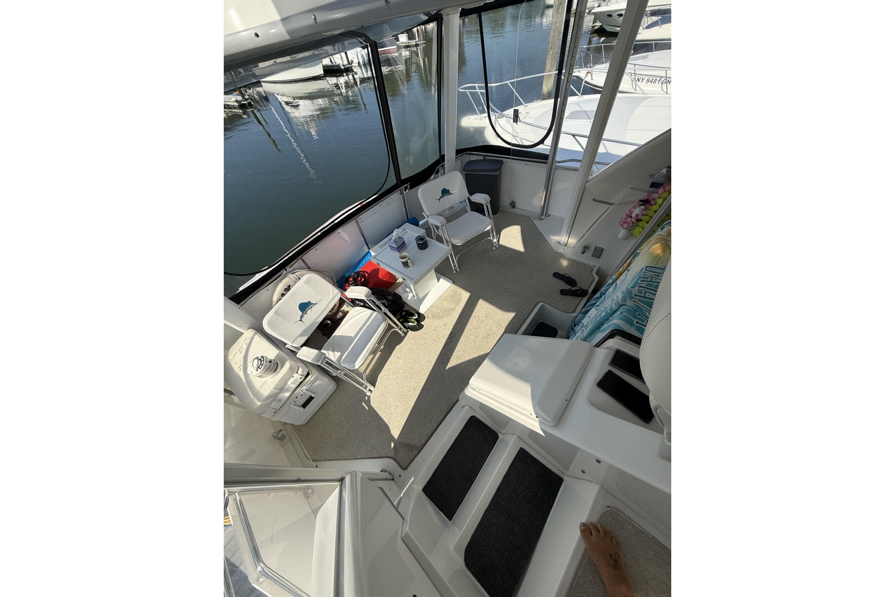 1993 Carver 350 Motor Yacht interior with chairs and table, docked at marina.