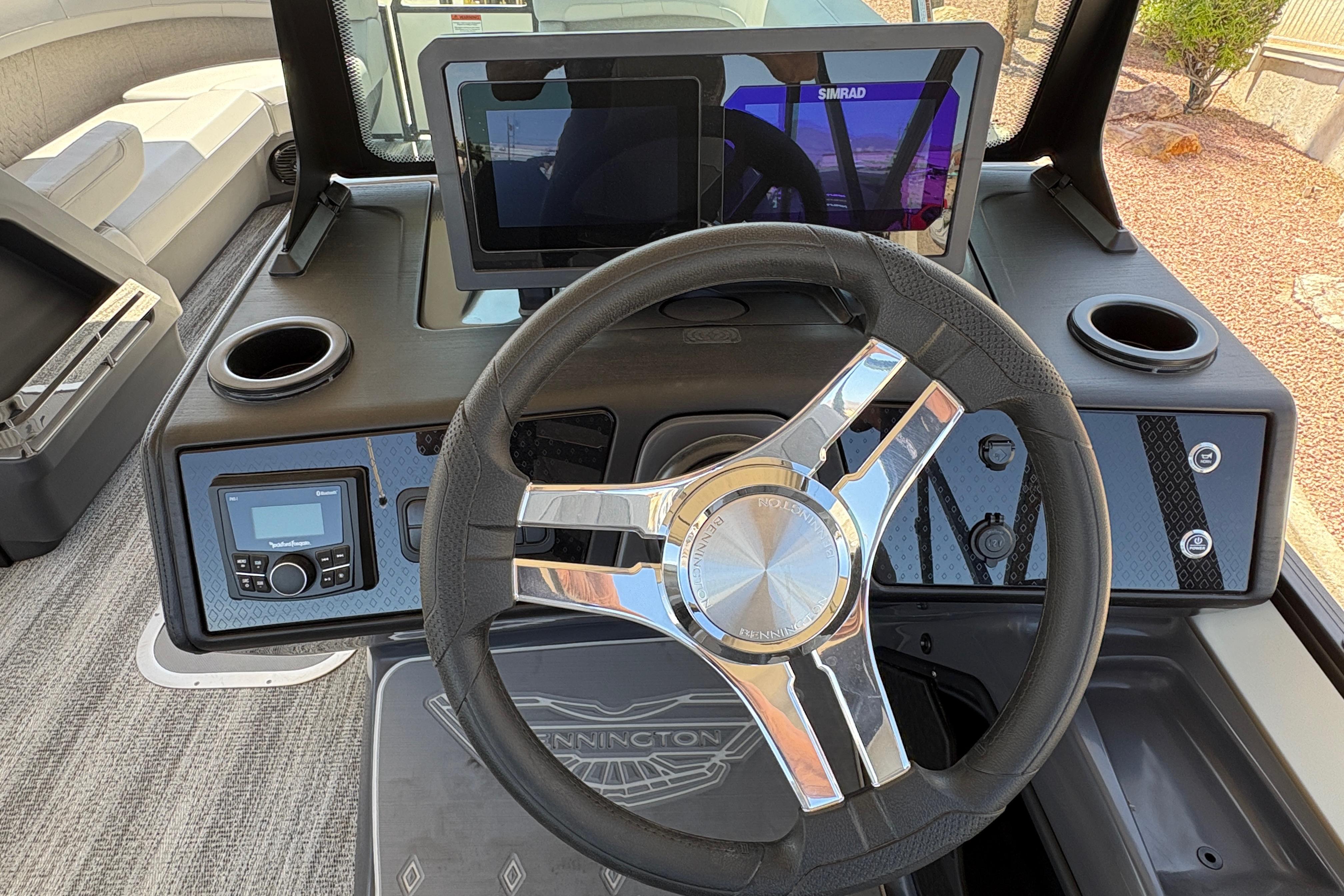 Steering console of 2026 Bennington 24 MSB boat with modern controls and touchscreen display.