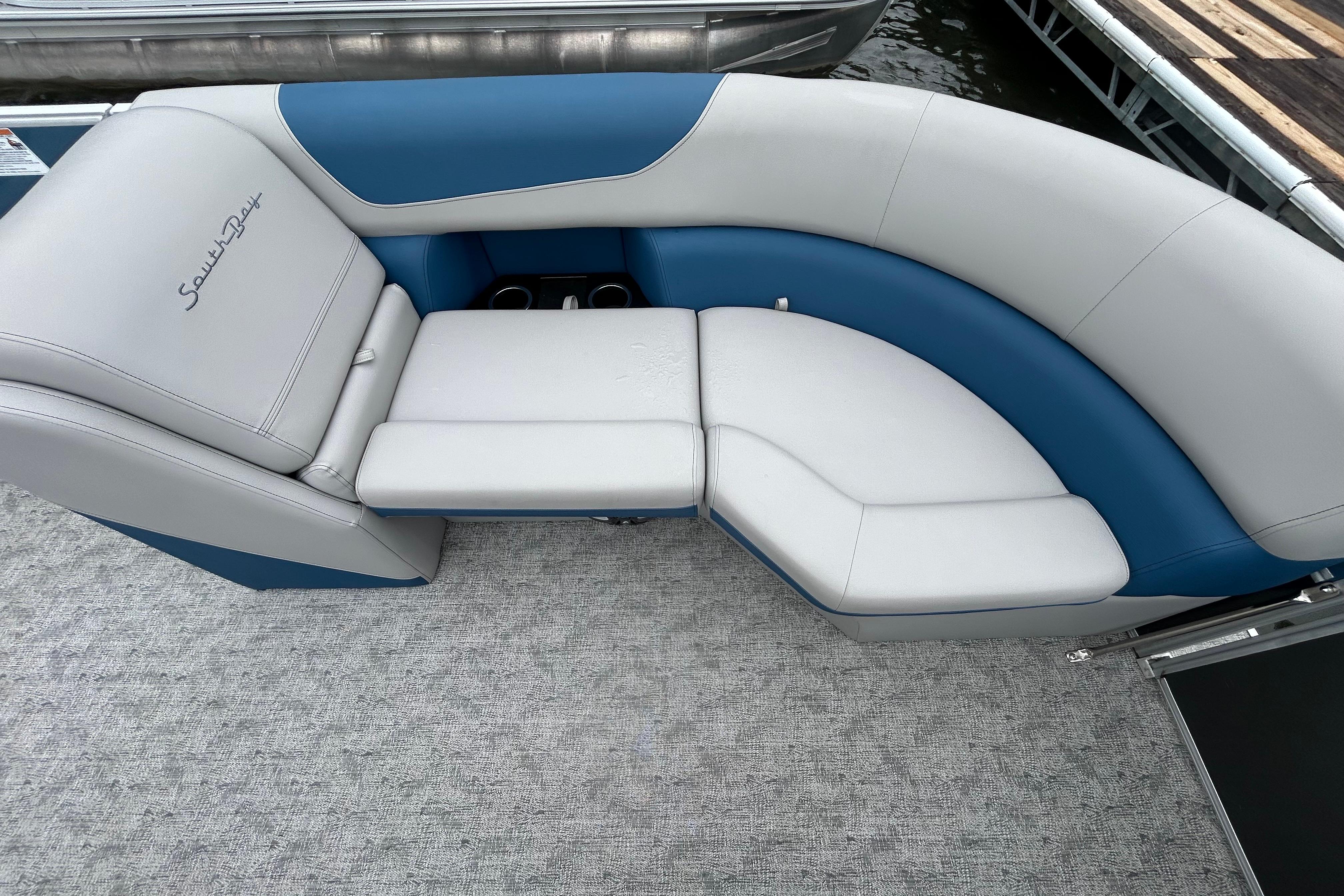 Luxurious seating on 2025 Southbay 224RSLE275 pontoon boat, featuring blue and gray upholstery.