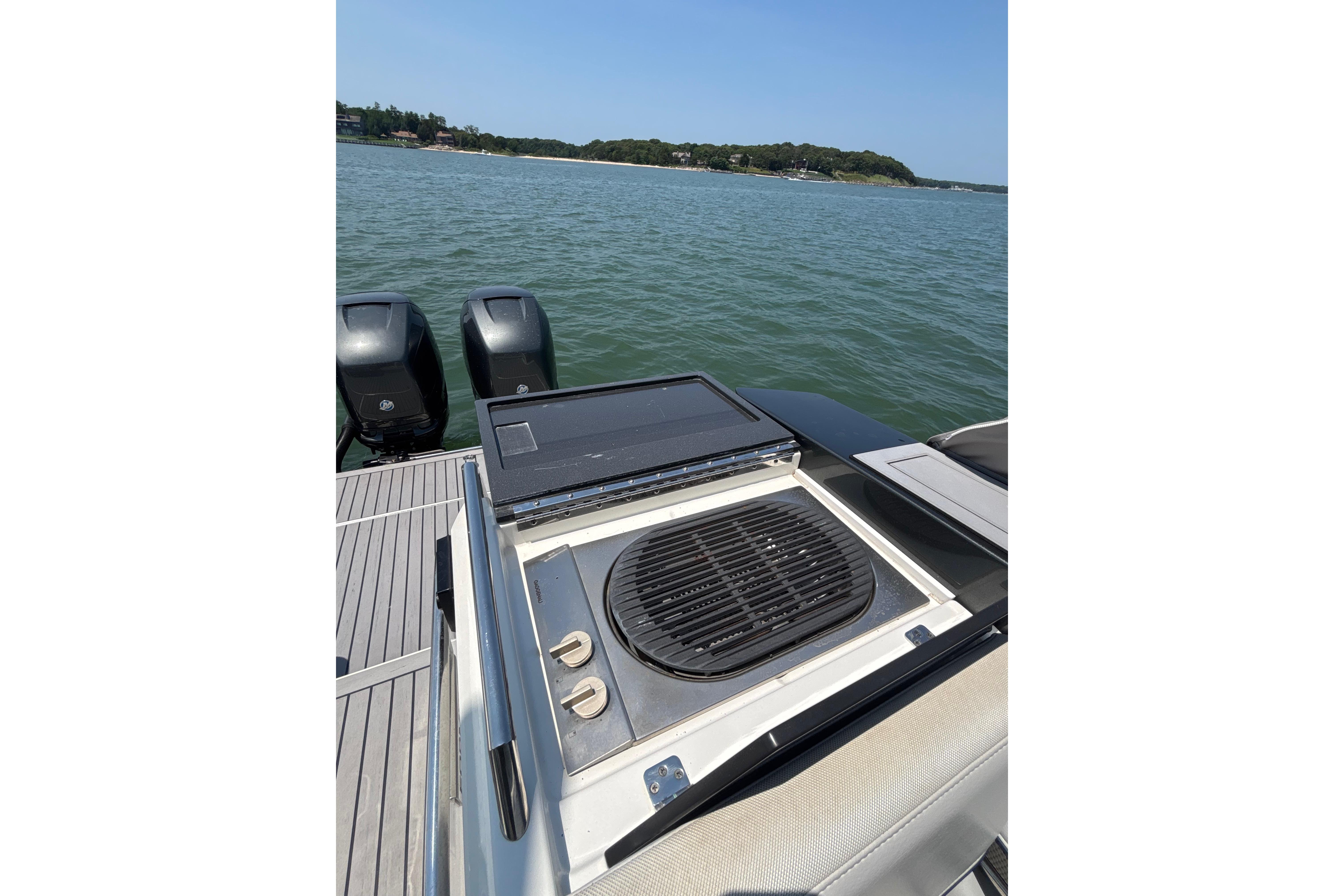 Outdoor grill on 2019 Formula 430 Super Sport Crossover yacht, with scenic water view.