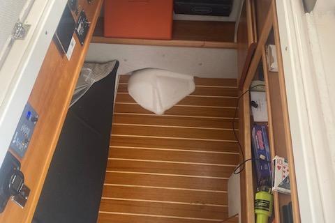2020 Cutwater C-32 C cabin interior with wood flooring and storage compartments.