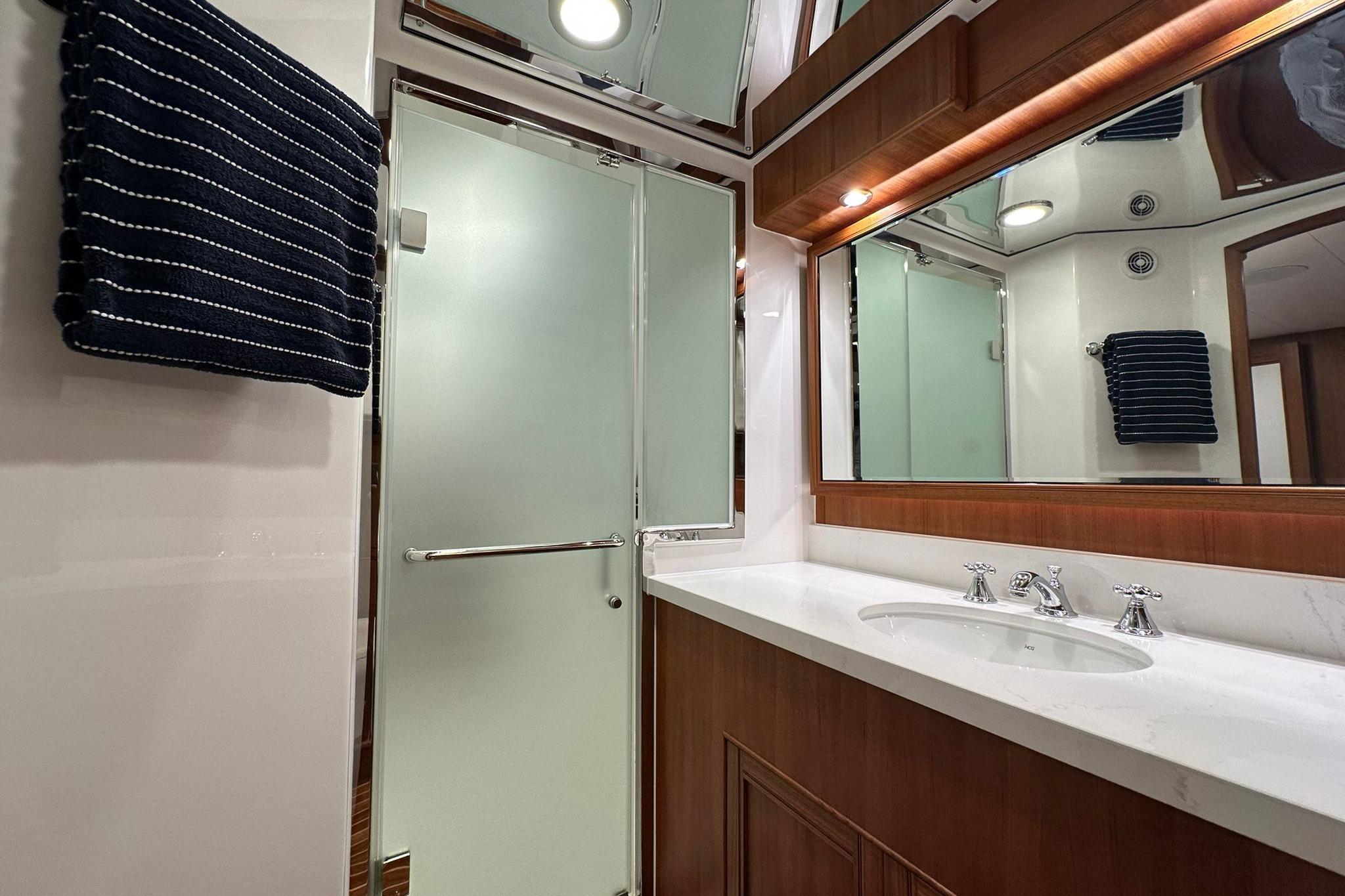 Luxurious bathroom in 2023 Marlow Explorer 66E-CB yacht with modern fixtures and elegant design.