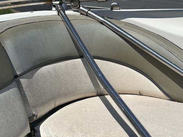Interior seating of a 2005 Sea Ray 240 SD boat with metal railings.