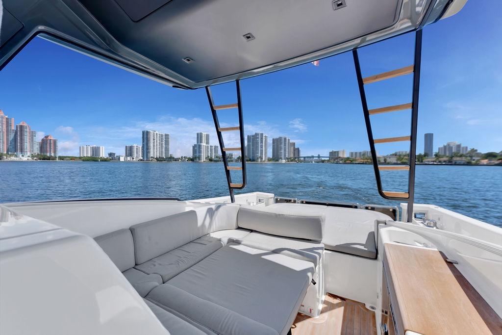 Luxurious 2021 Bluegame BG 42 yacht interior with stunning waterfront cityscape view.