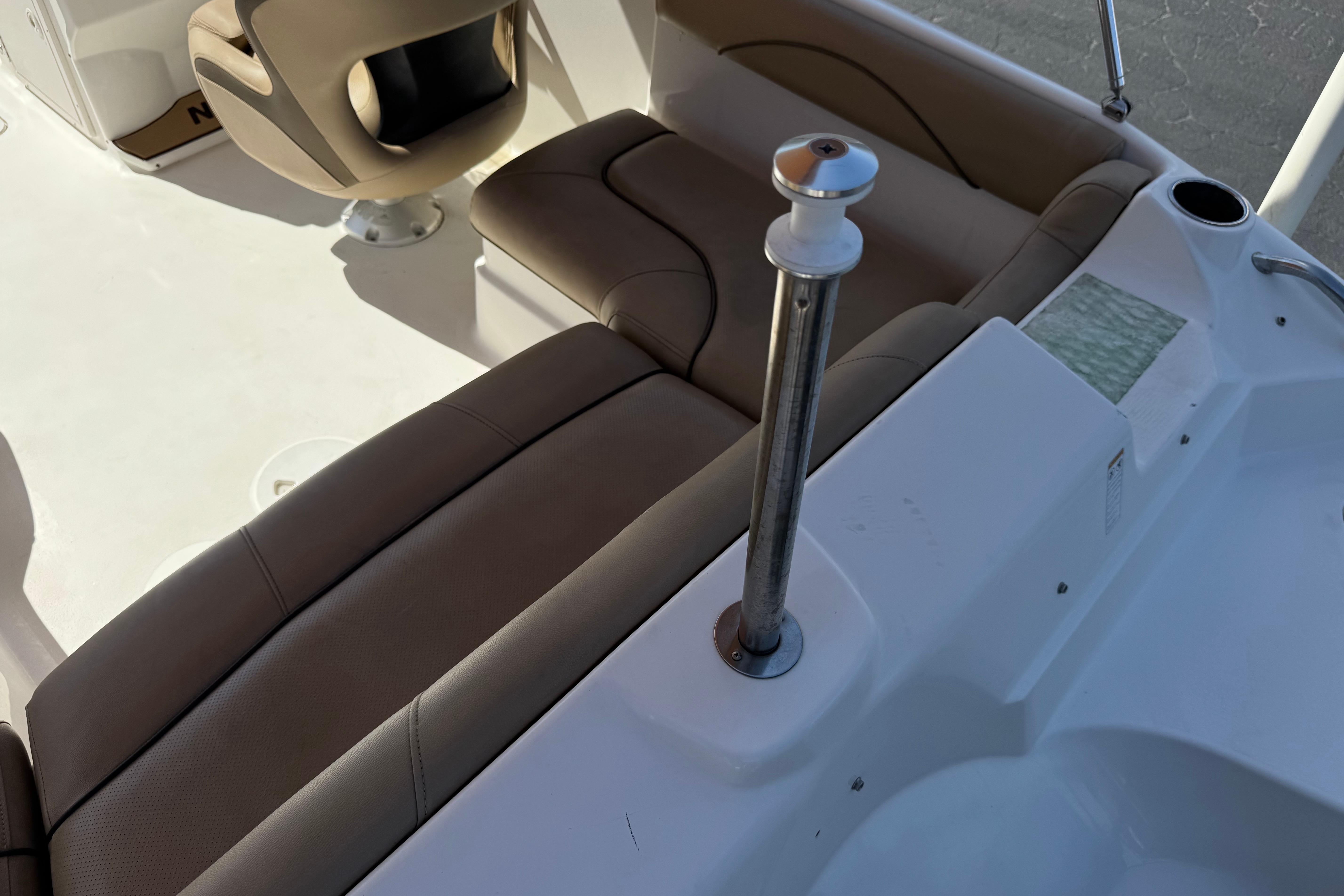 Interior of 2020 NauticStar 203 SC boat with beige seating and white deck.