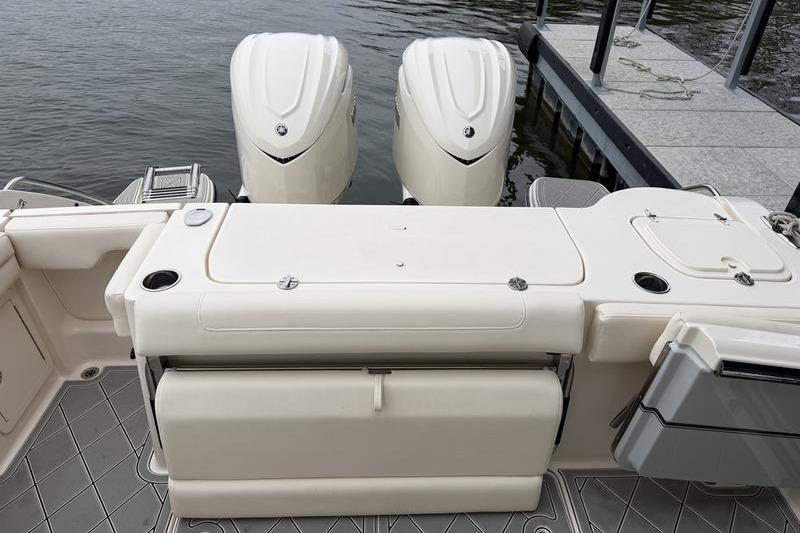 2025 Grady-White Freedom 325 boat with dual engines docked by the water.