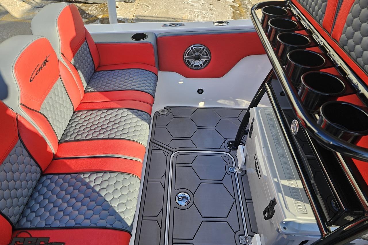 Interior of 2025 Concept 27' CC boat with red and gray seating and cup holders.