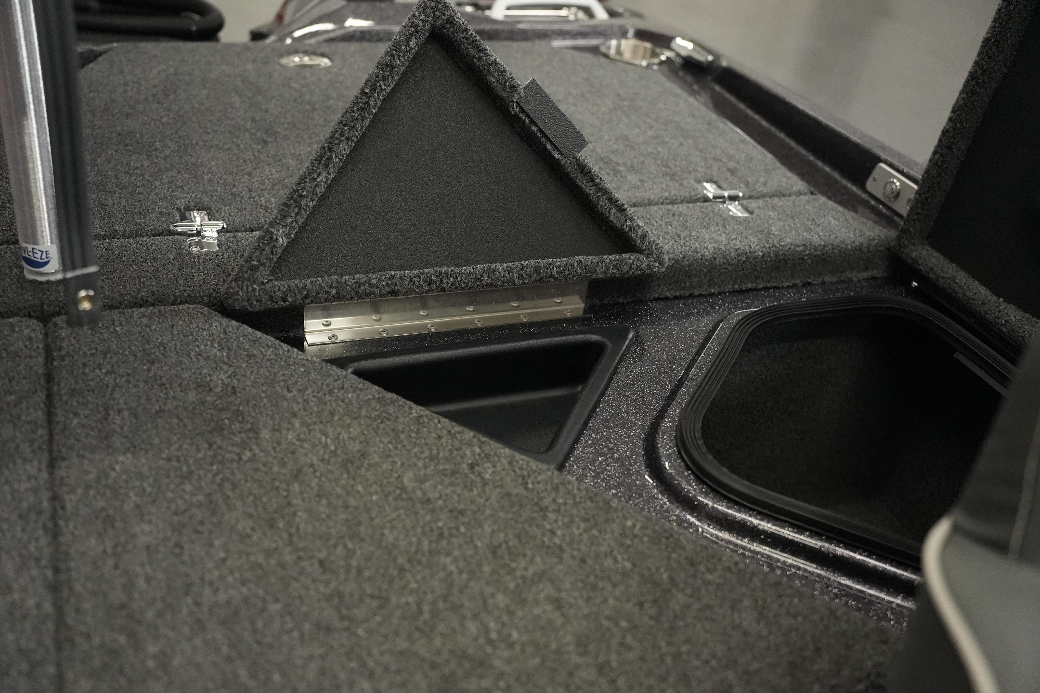 2026 Bass Cat Puma STS boat storage compartments with carpeted lids and secure latches.