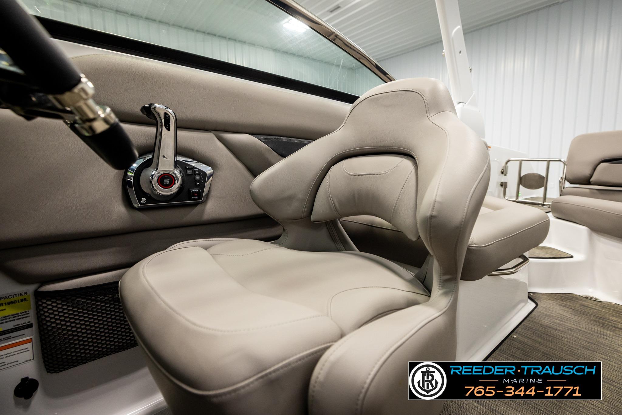 2024 FOURWINNS HD5 Surf boat interior with beige seating and control panel.