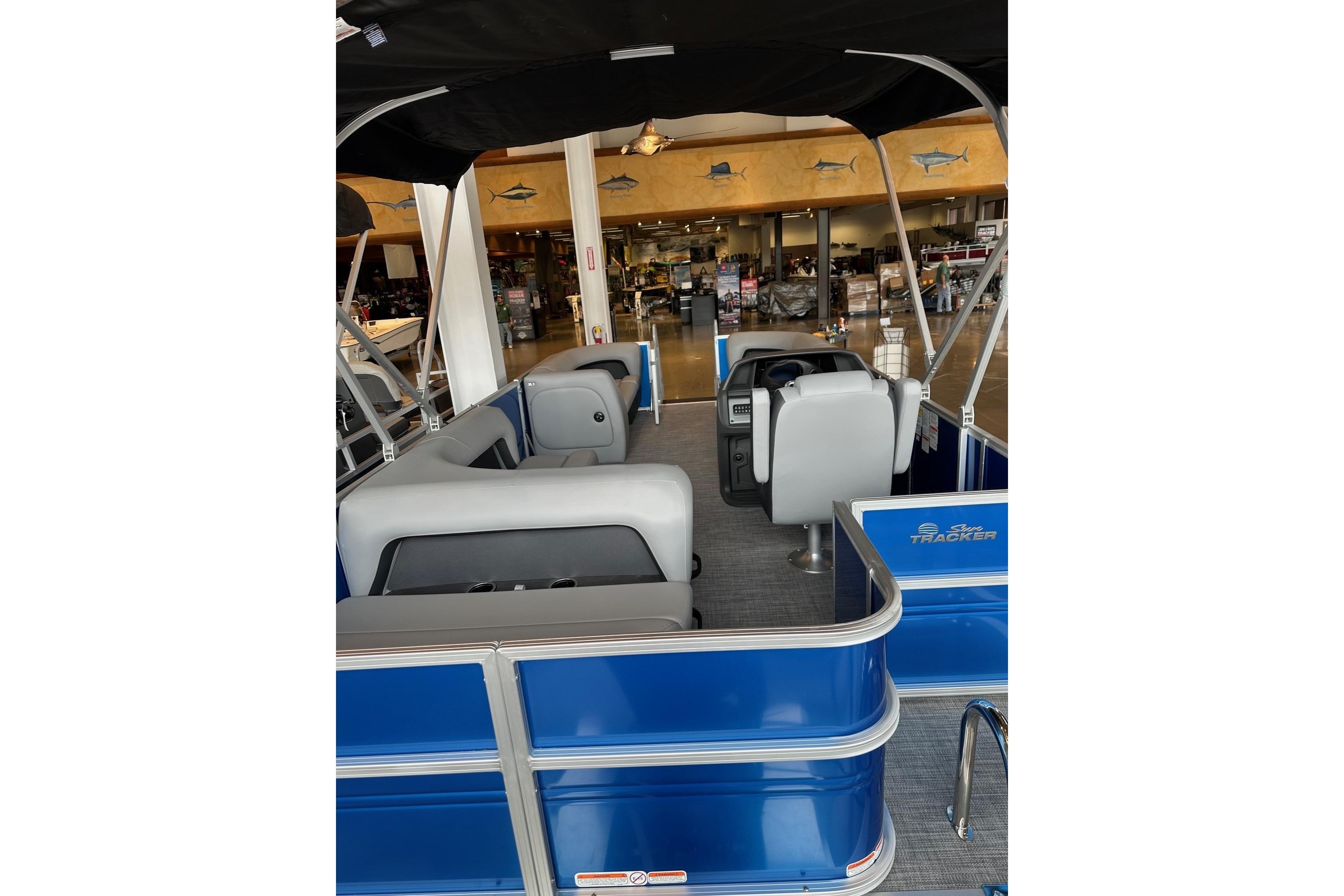 Interior view of 2026 Sun Tracker Party Barge 18 DLX pontoon boat in showroom.
