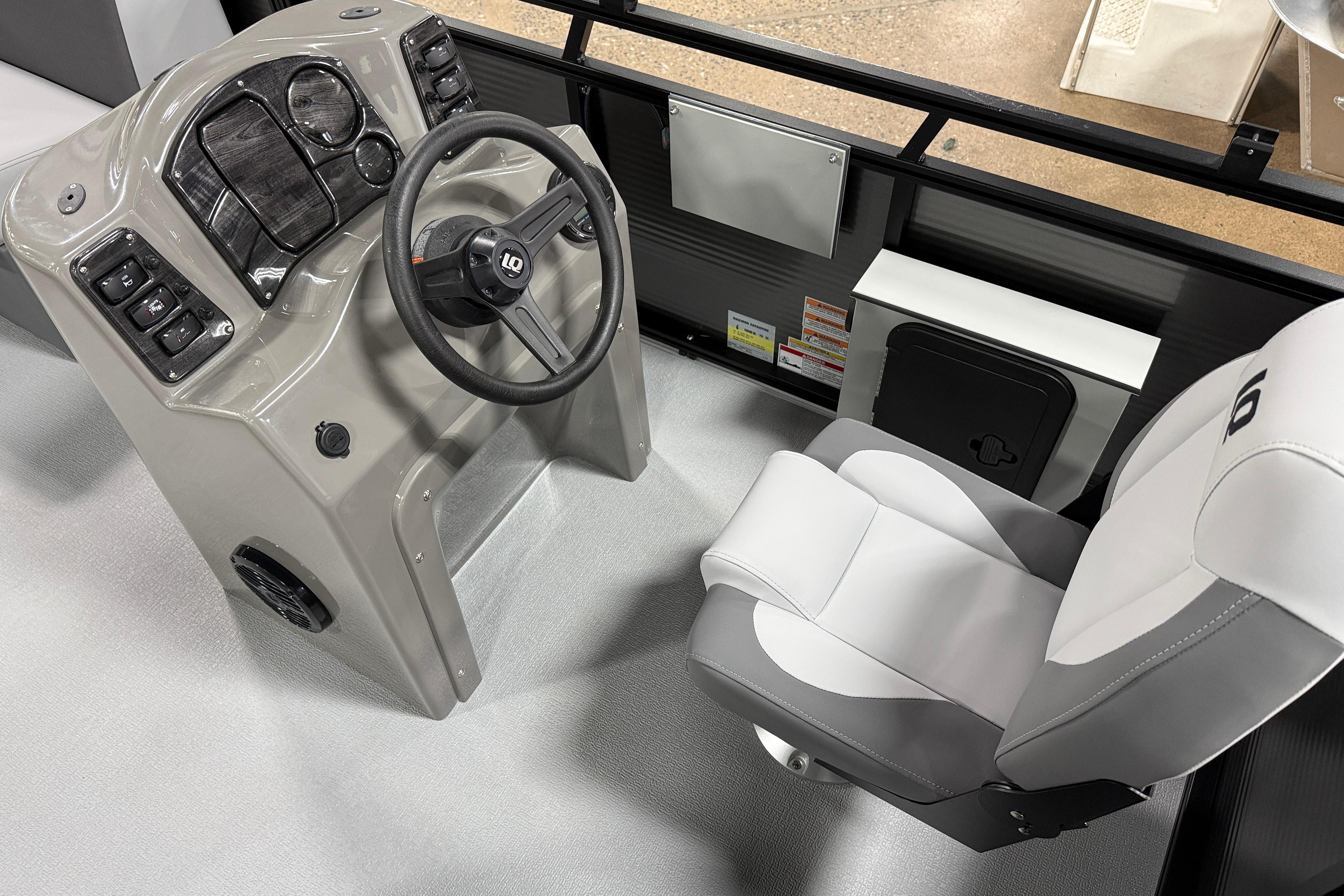 Captain's seat and helm of 2026 Angler Quest 7515 Leisure Quest Cruise boat.