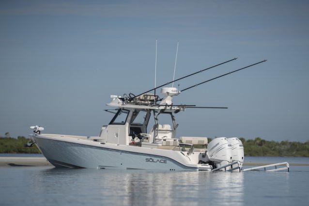 Manufacturer Provided Image: 2026 Solace 30 HCS boat on calm water, equipped with fishing rods and dual engines.