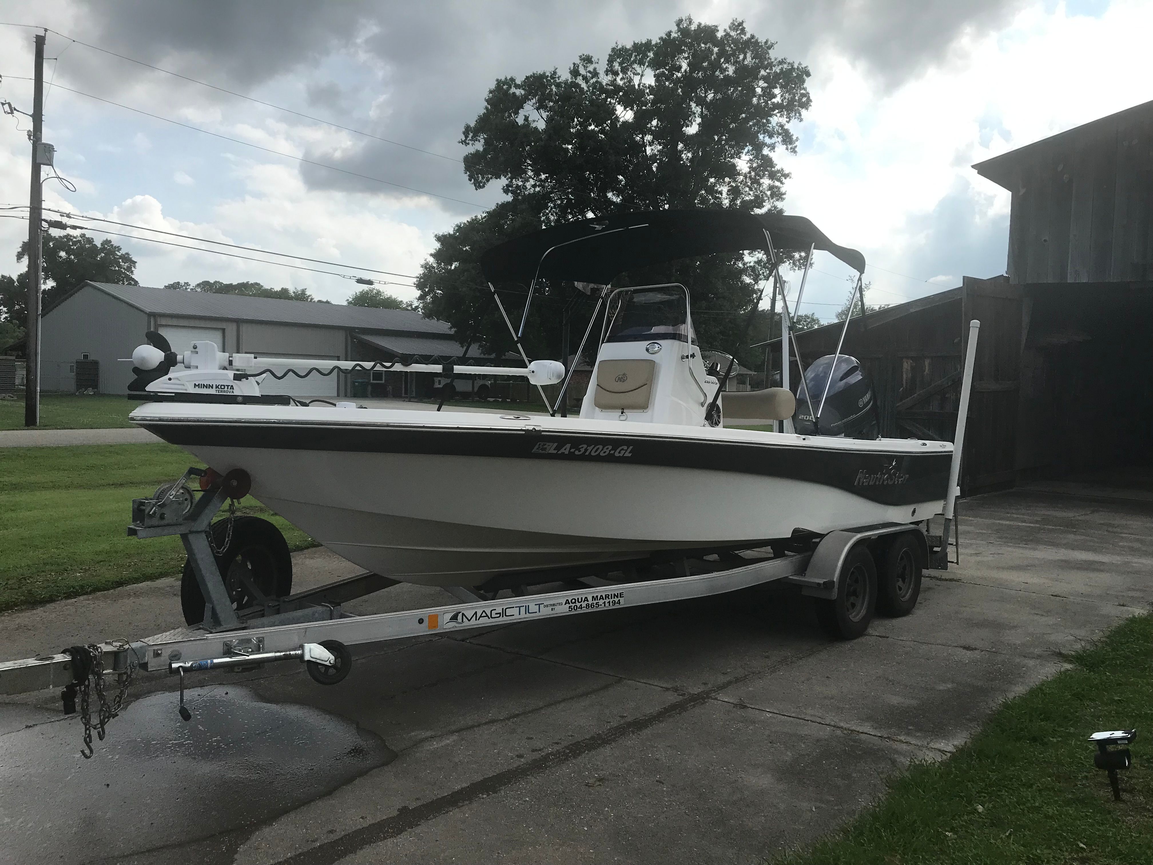 2020 NauticStar 215 XTS boat parked on trailer outdoors.