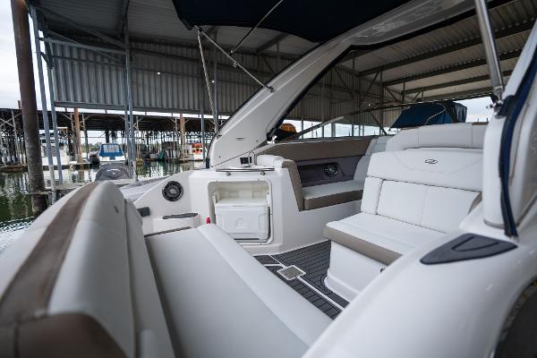 2016 Regal 28 Express boat interior with seating and storage, docked in a covered marina.