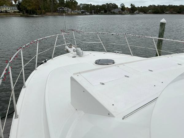 Novatec Islander 55 yacht deck, 2000 model, docked by a serene waterfront.
