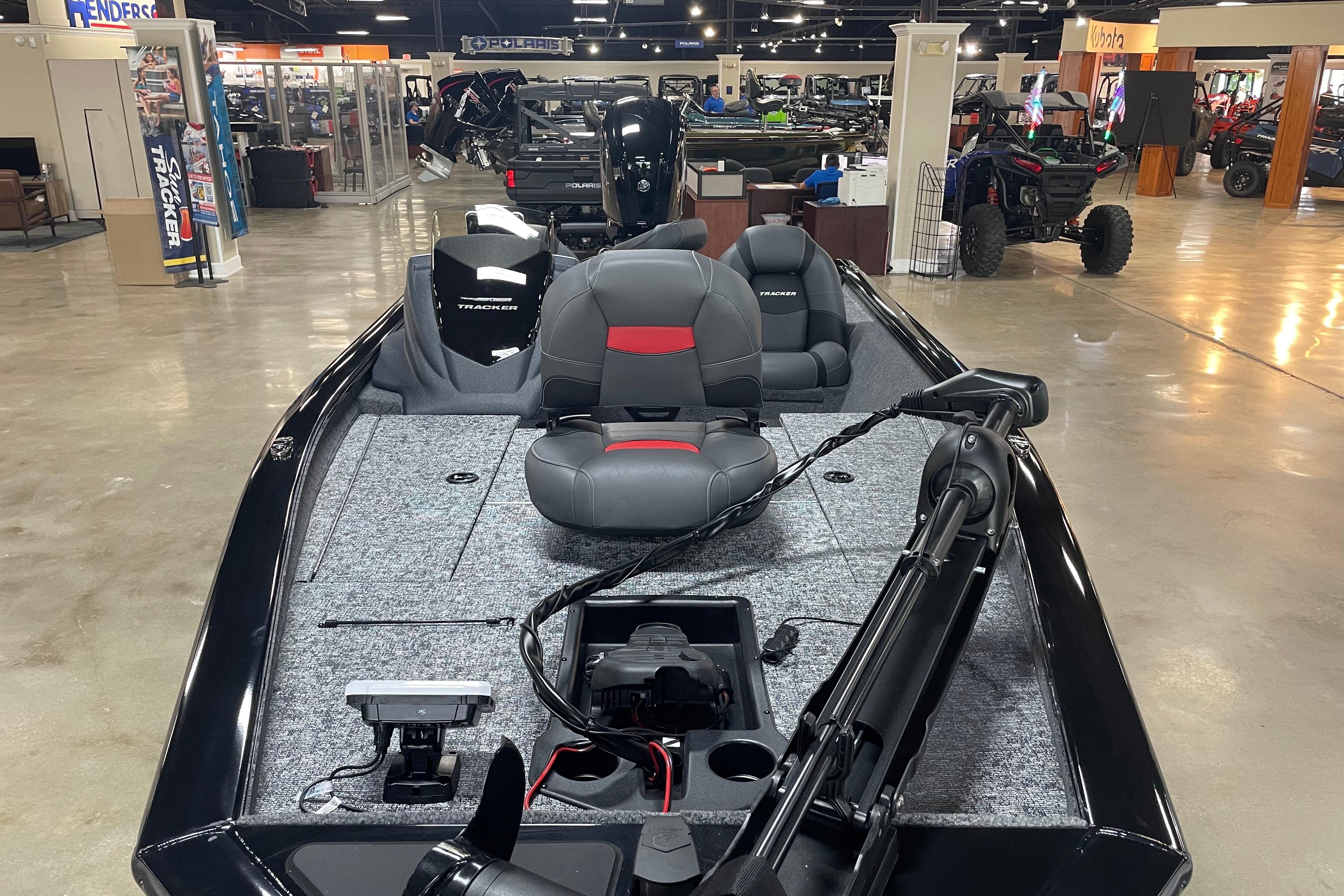 2026 Tracker Pro Team 175 Crappie Edition boat displayed in showroom, featuring sleek design and seating.