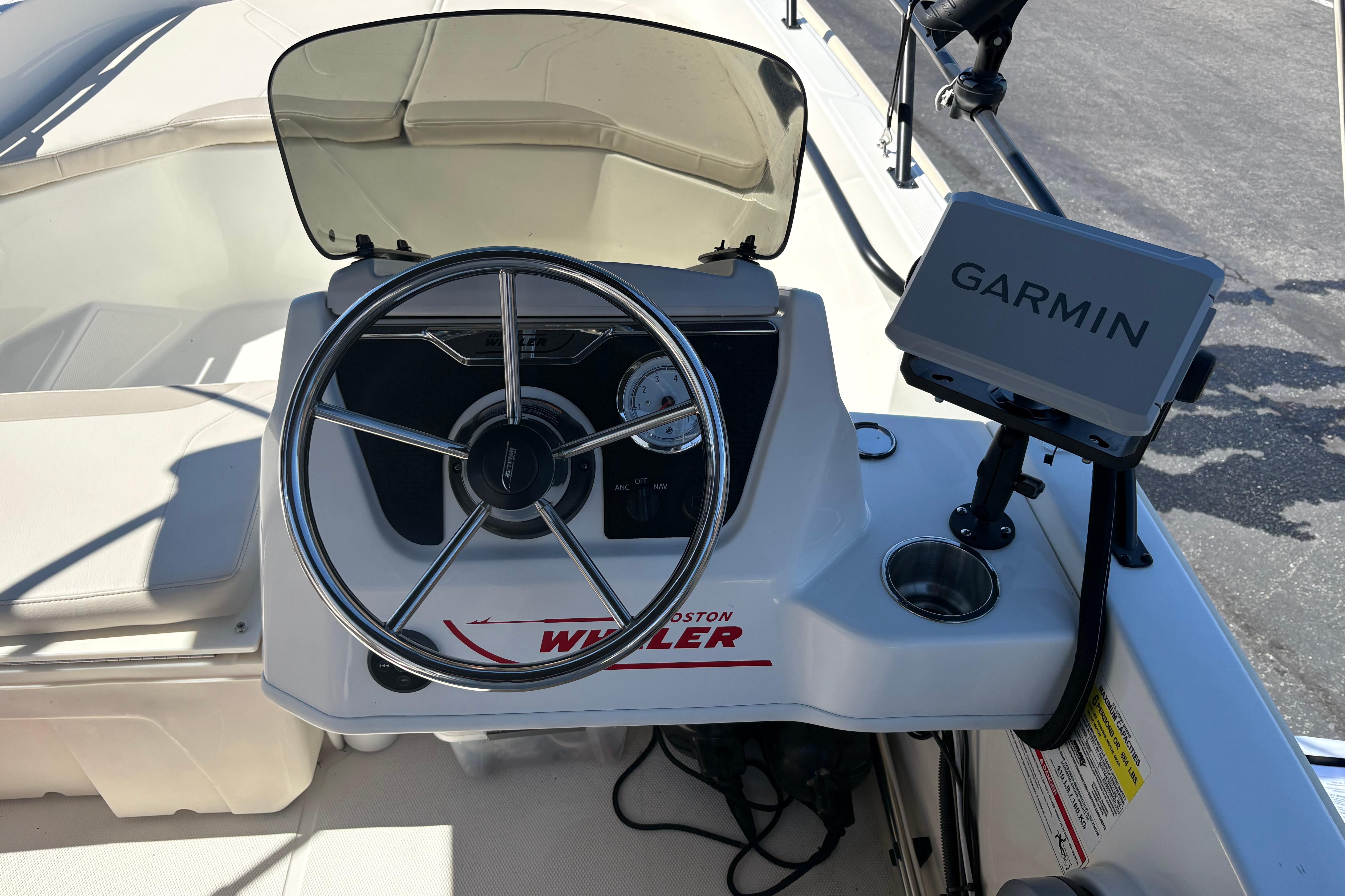 2024 Boston Whaler 160 Super Sport dashboard with Garmin navigation system and steering wheel.