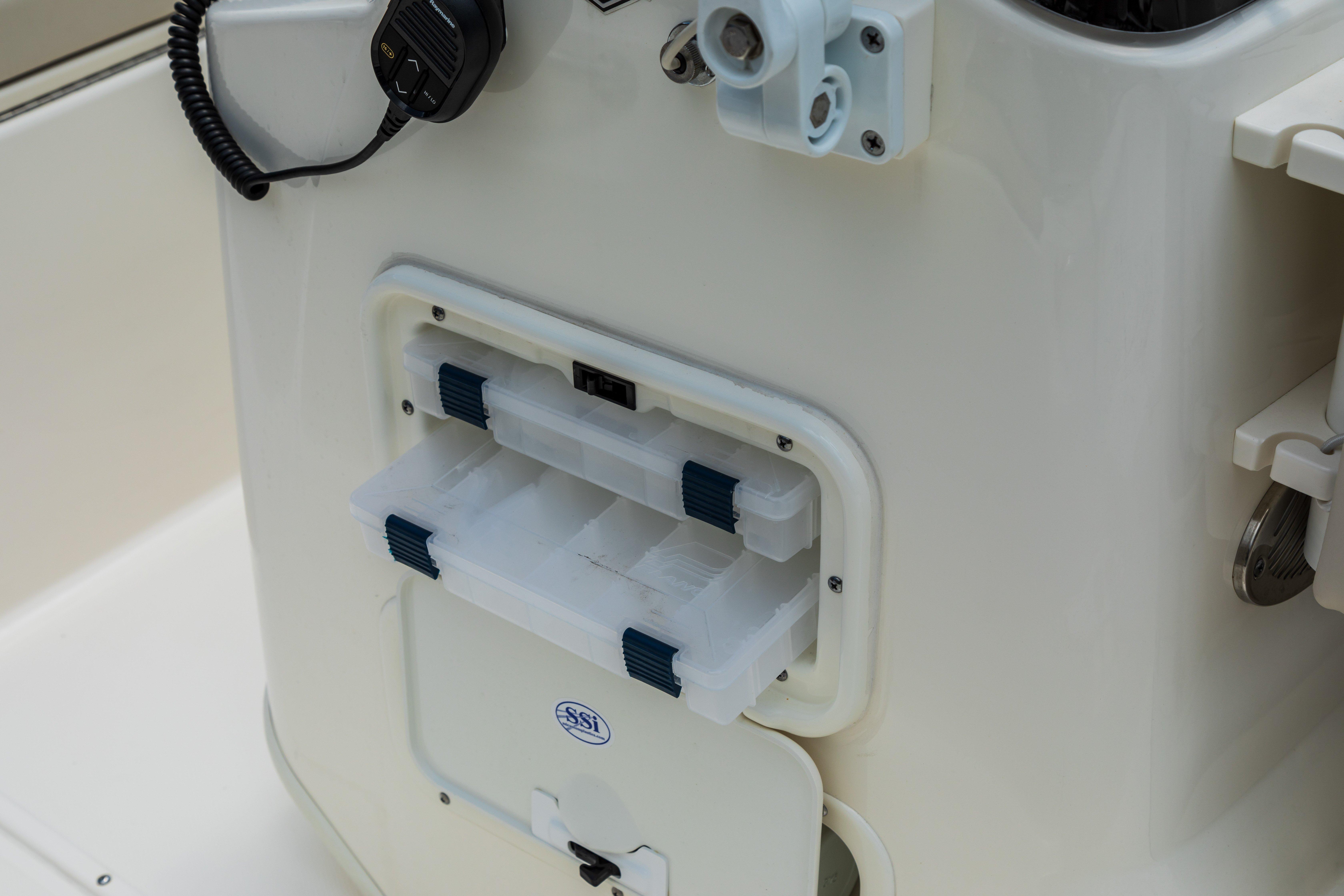 2025 Boston Whaler 170 Montauk boat console with storage compartments and radio.
