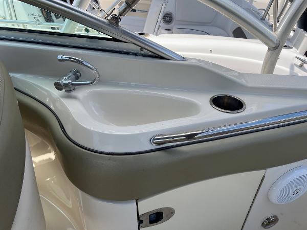 2005 Sea Ray 220 Sundeck boat interior with sink and cup holder.